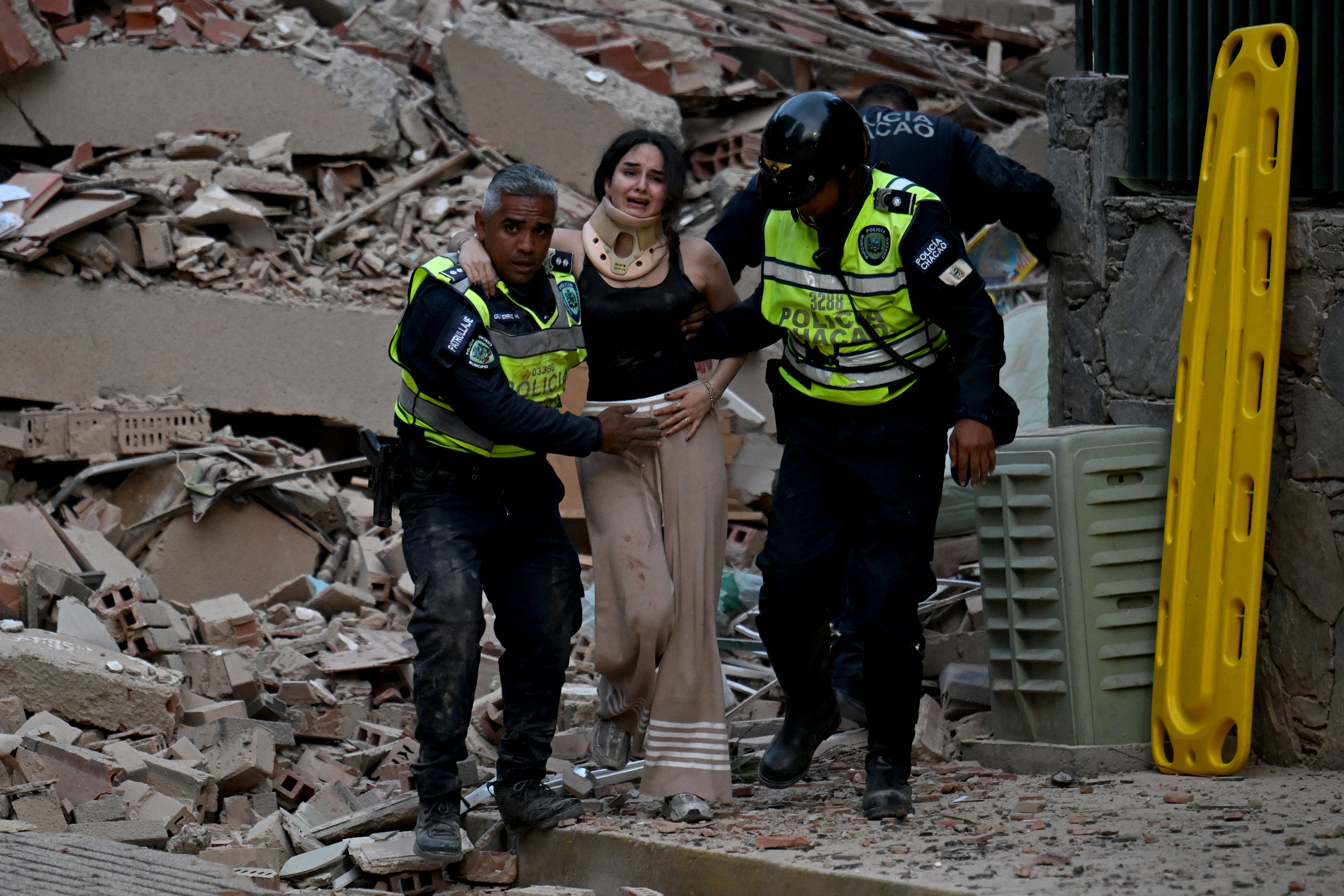 Police officers evacuate an injured victim from a collapsed building. (Juan Barreto/AFP/Getty)