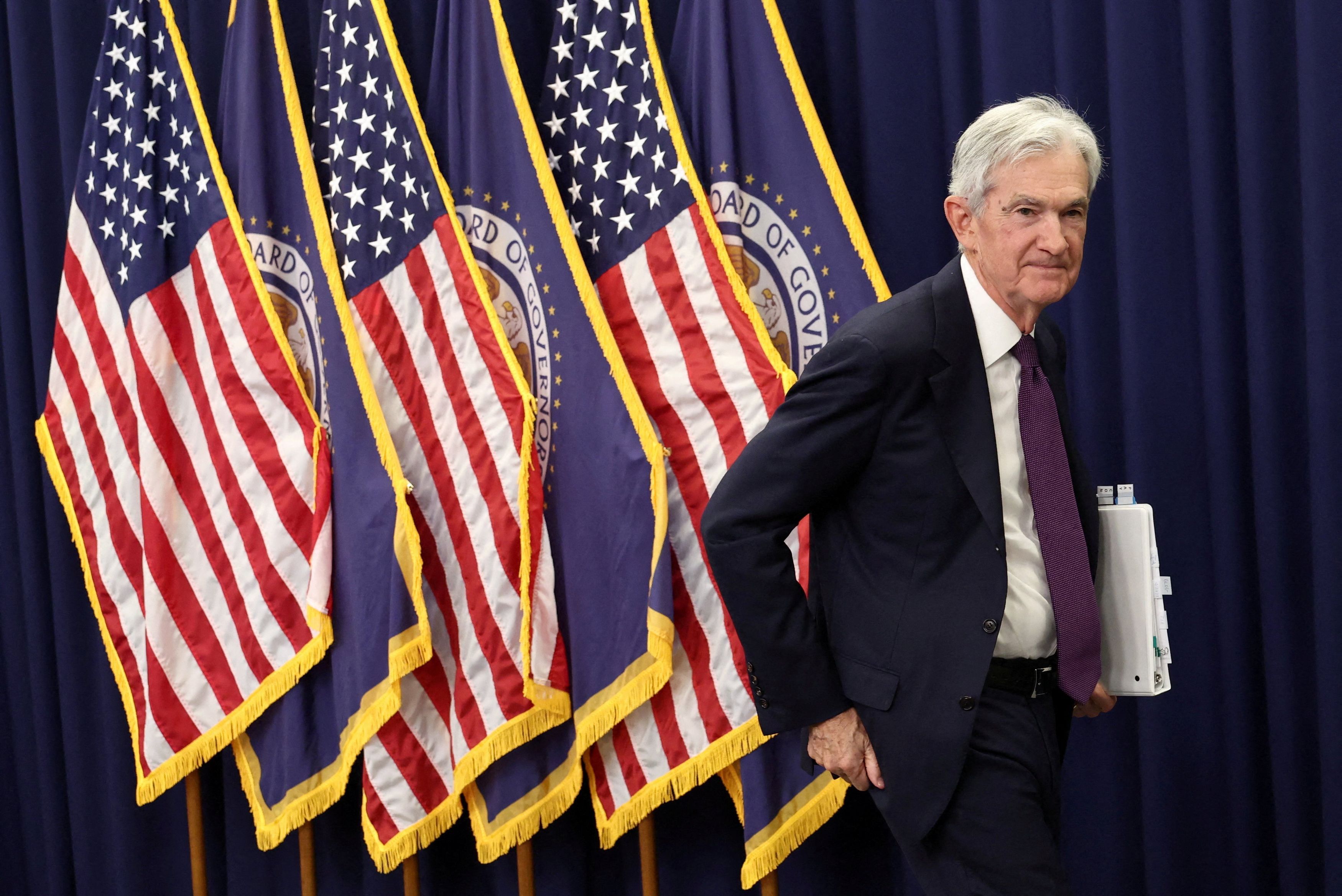 Federal Reserve Chair Jerome H. Powell departs a news conference in D.C. on Wednesday. (Kevin Lamarque/Reuters)