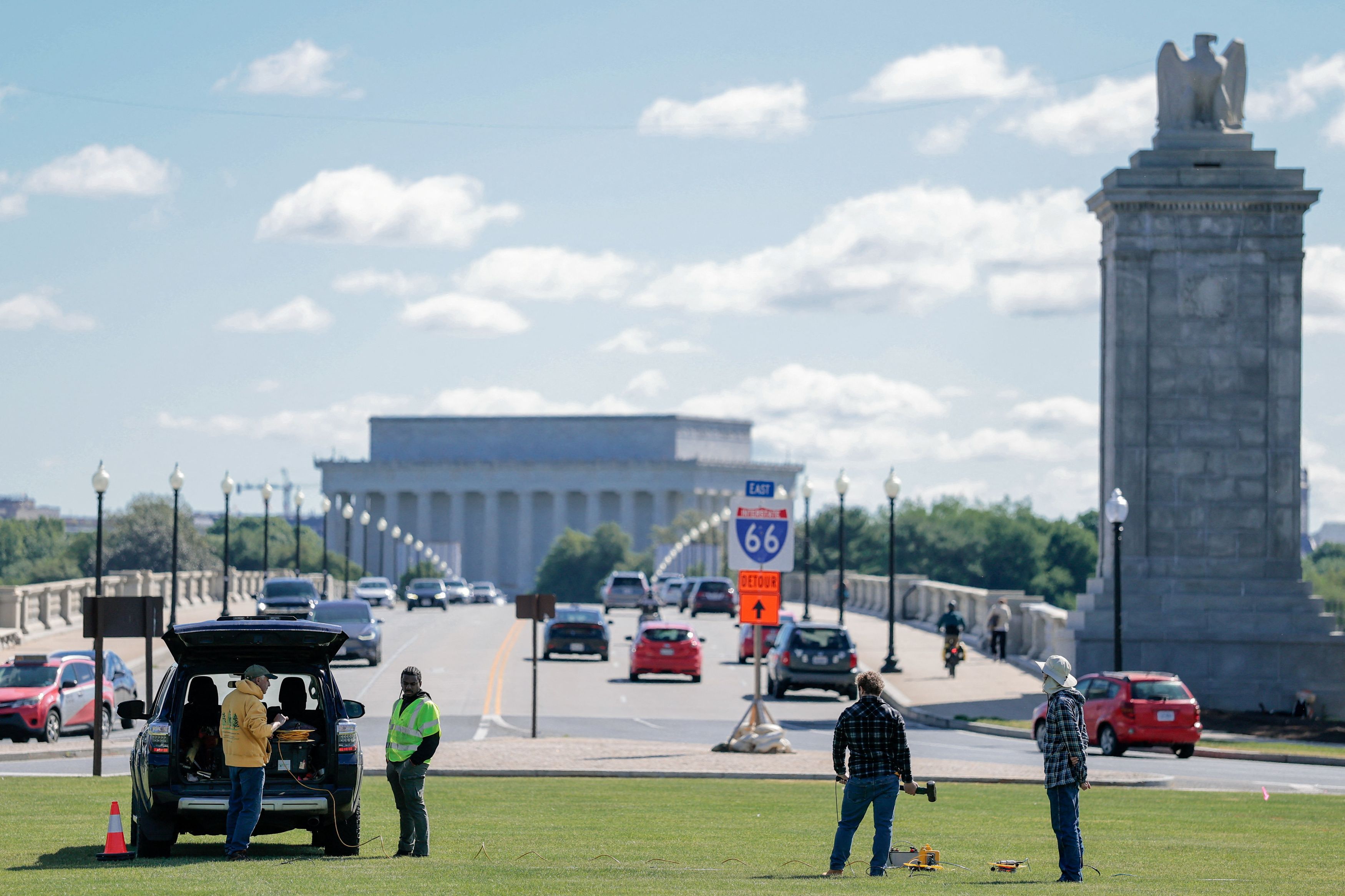 Workers take measurements on May 15 at Memorial Circle, the proposed site for President Donald Trump’s triumphal arch. (Kylie Cooper/Reuters)