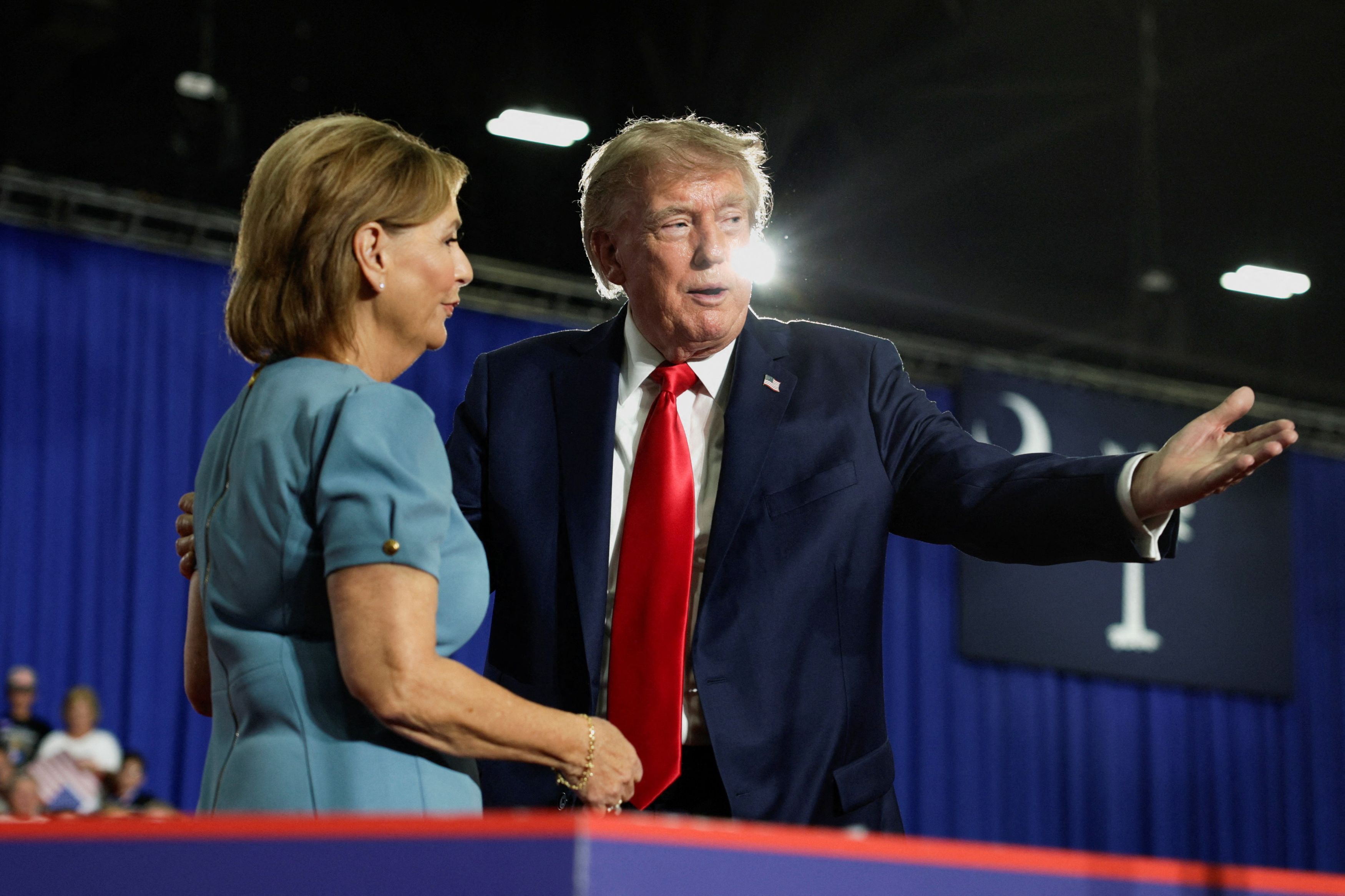 President Donald Trump welcomes Sen. Darline Graham (R-South Carolina) onstage during a campaign rally on Friday. (Evan Vucci/Reuters)