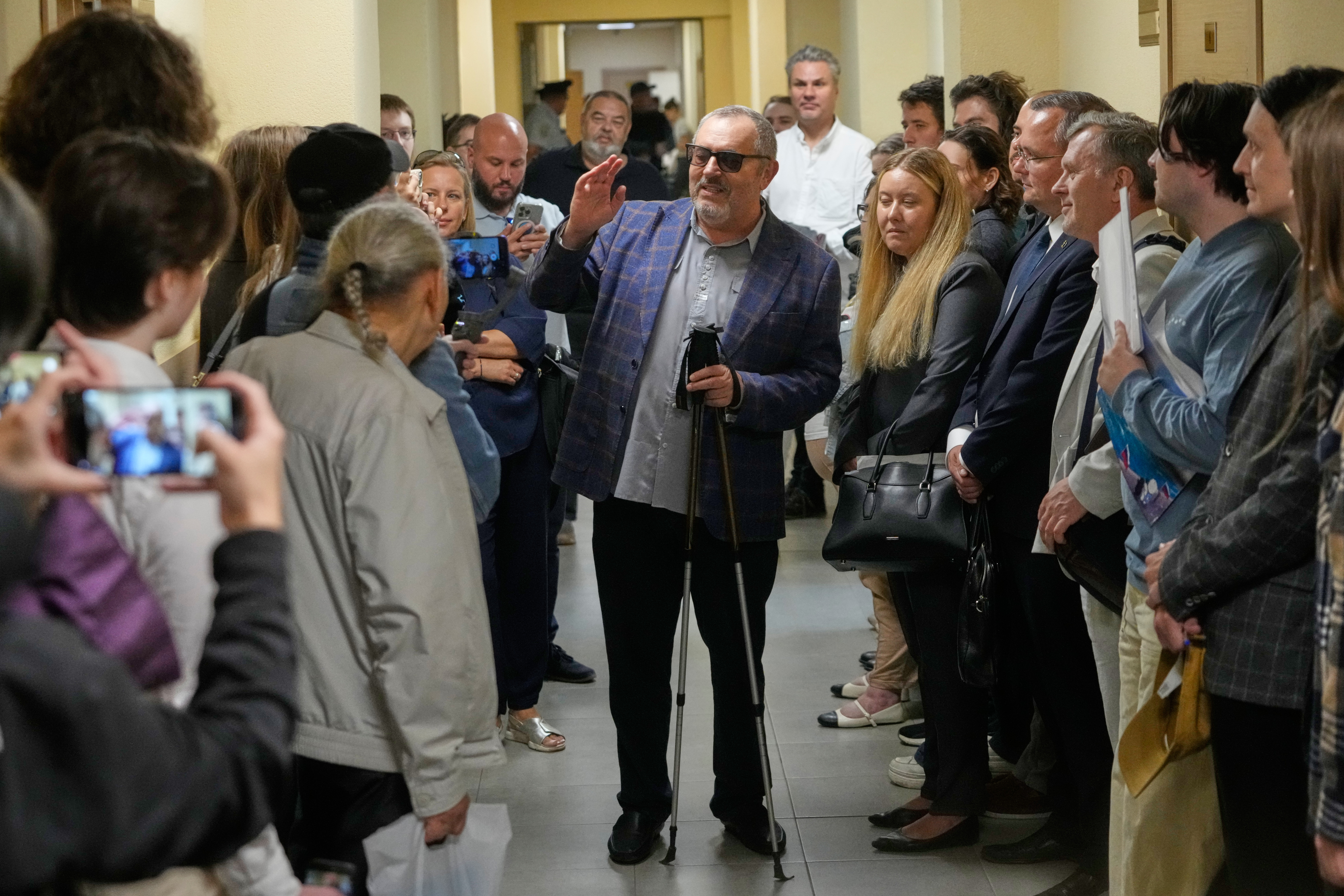Russian politician Boris Nadezhdin, accused of displaying "extremist symbols," speaks to journalists as he arrives at the courtroom in the town of Dolgoprudny, outside Moscow, in July. (Pavel Bednyakov/AP)