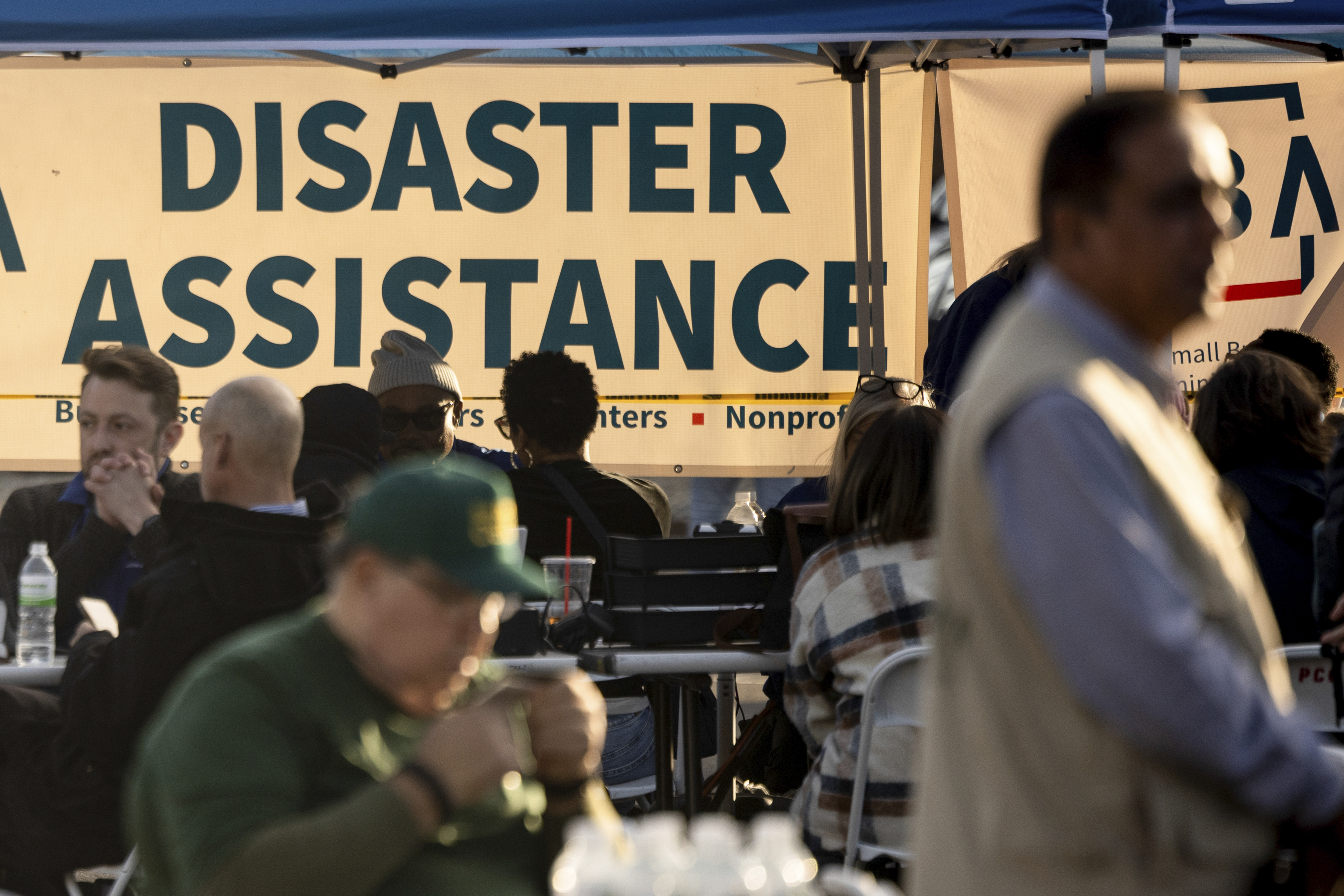 People impacted by wildfires seek information and relief at a FEMA Disaster Recovery Center in January 2025, in Pasadena, California. (Etienne Laurent/AP)