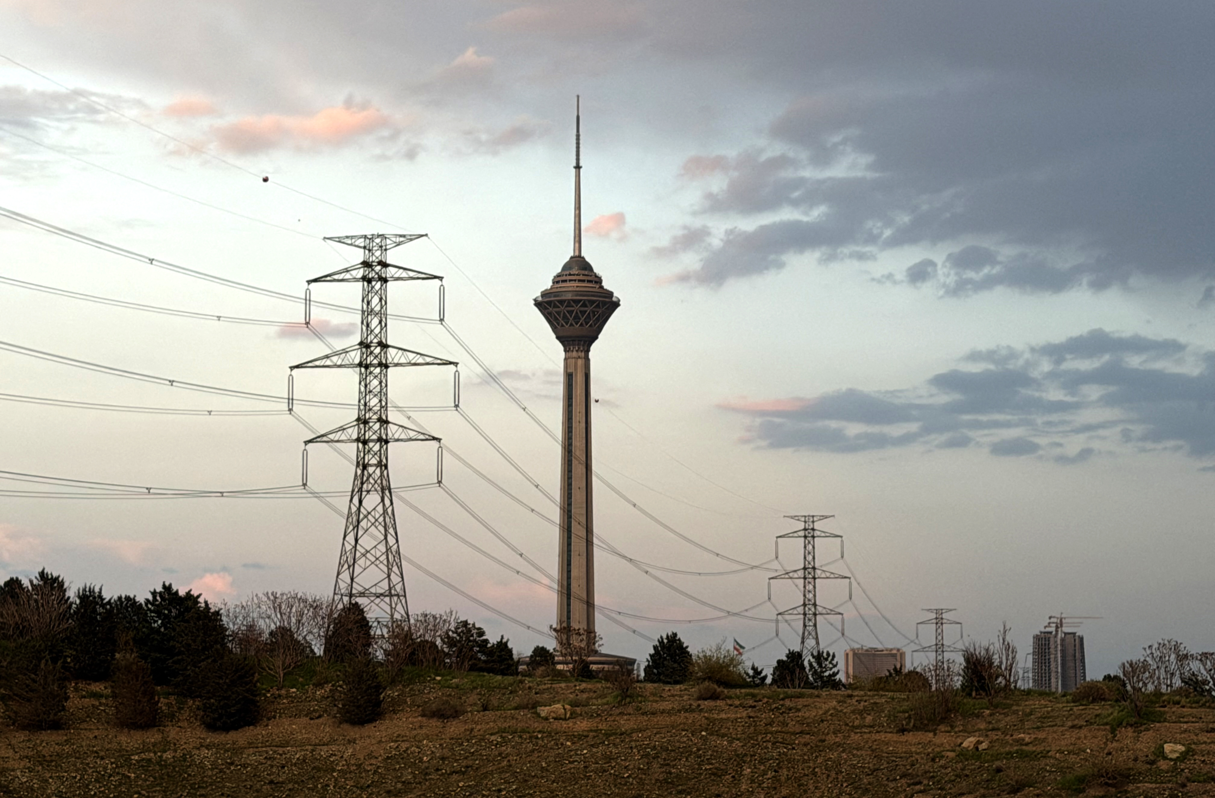 Power transmission towers and Tehran’s Milad Tower at sunset on Saturday. (Atta Kenare/AFP/Getty Images)