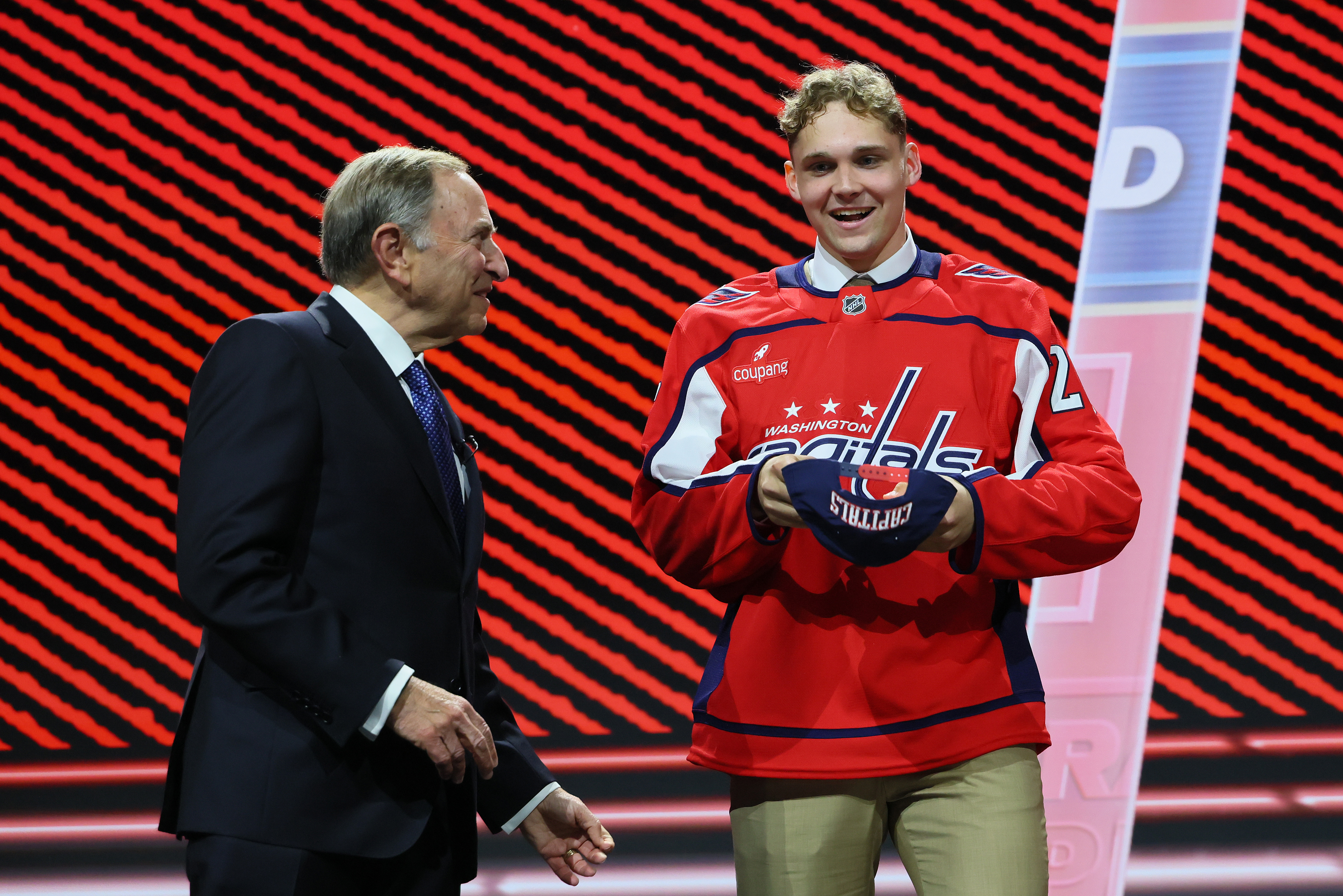 Oliver Suvanto of Finland, right, with NHL Commissioner Gary Bettman, sports a Capitals jersey after becoming Washington’s first-round pick in Friday’s NHL draft. (Bruce Bennett/Getty Images)