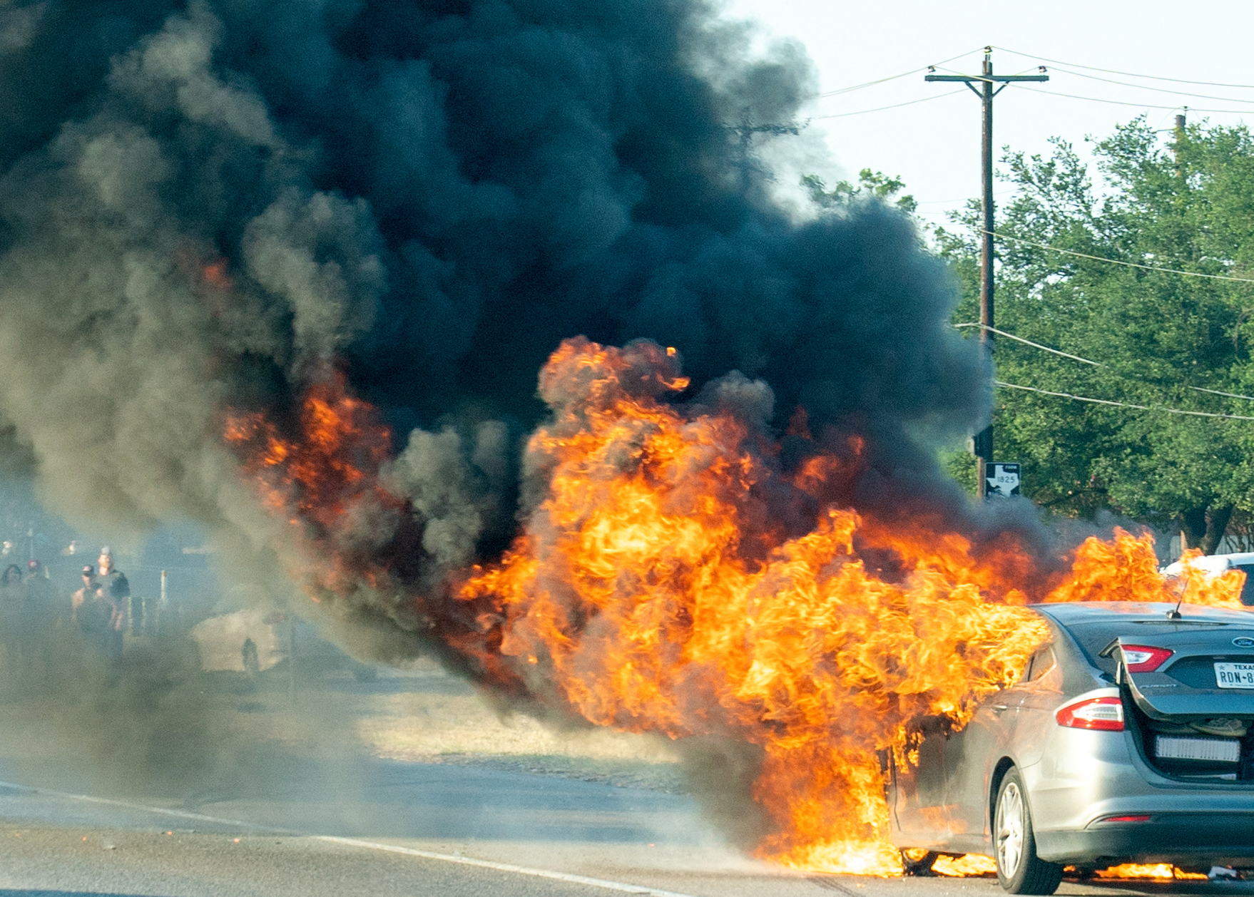 A car explodes into flames. (Suzanne Cordeiro/AFP/Getty Images)