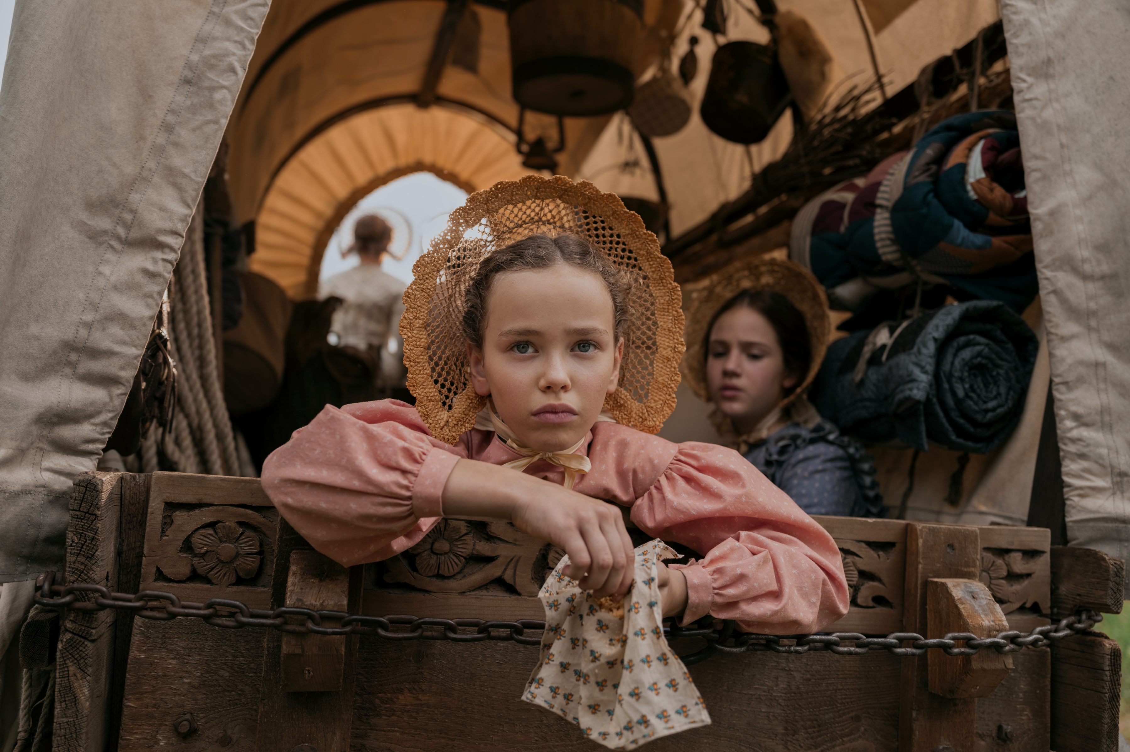 Laura looking out the back of a wagon in "Little House on the Prairie." (Eric Zazchanowich/Netflix)