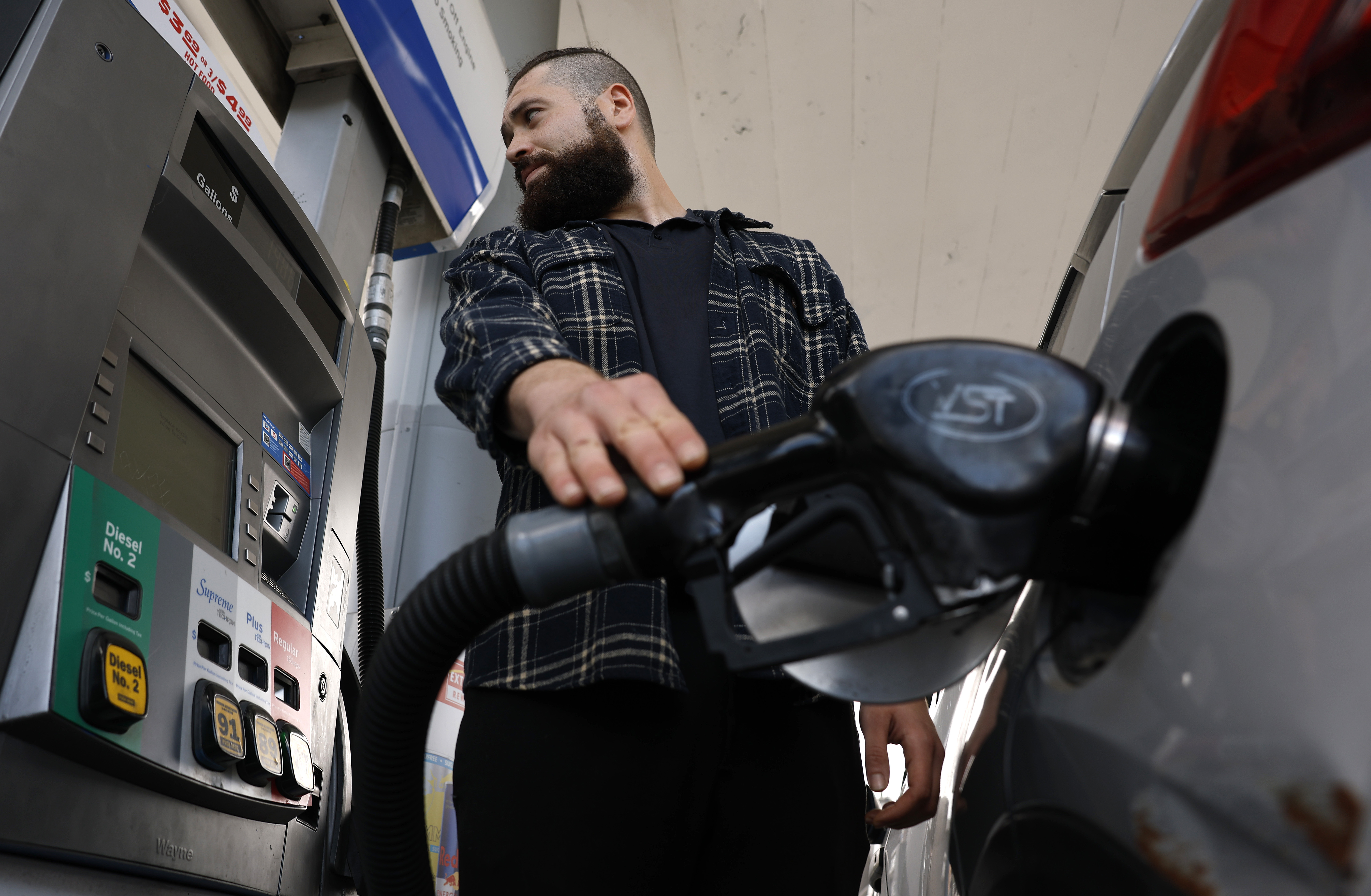 A customer pumps gas into his car at a Chevron station on May 4 in Los Angeles. (Justin Sullivan/Getty Images)
