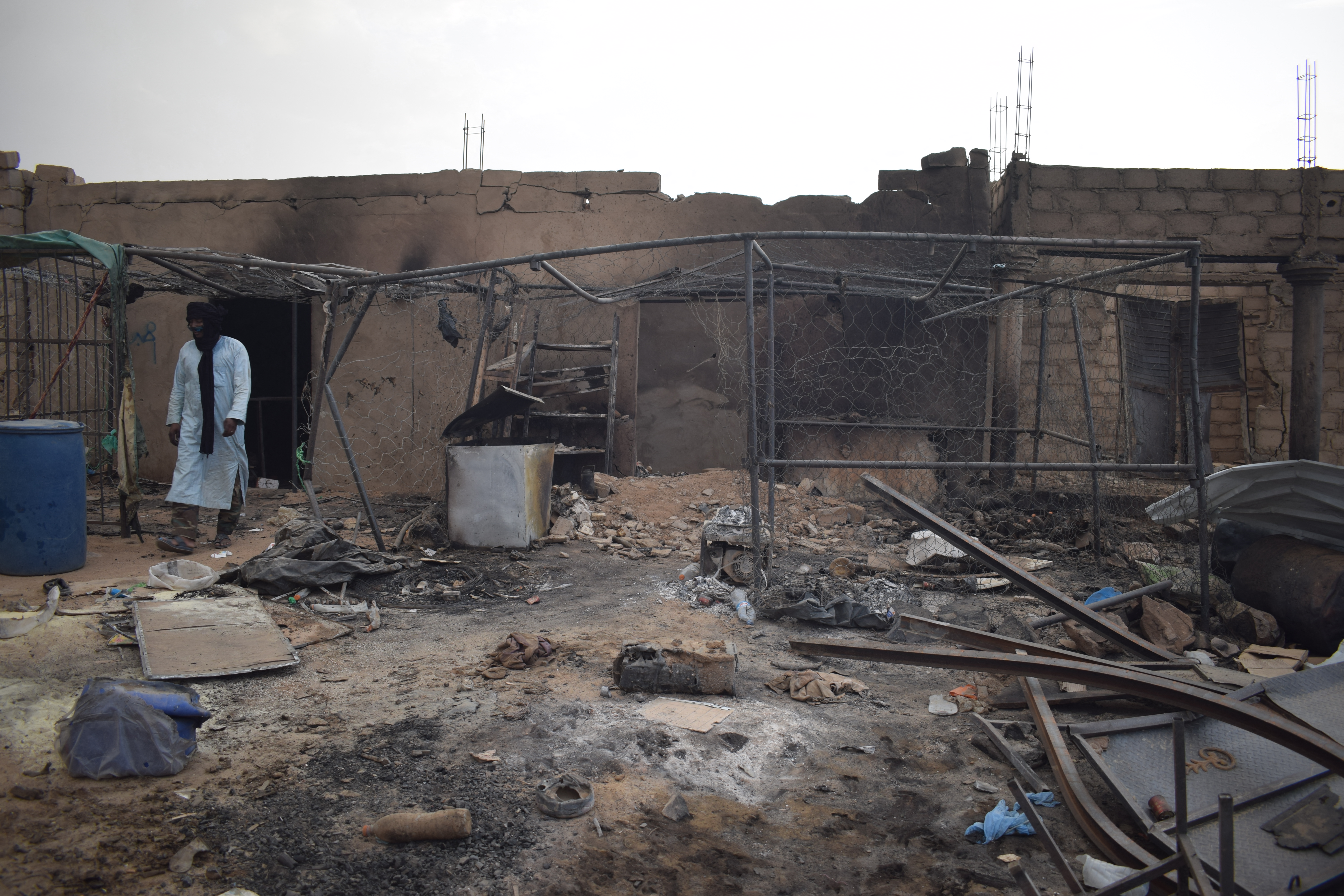 A man walks through the wreckage of a drone attack near Mali’s border with Algeria on July 8. (AFP/Getty Images)