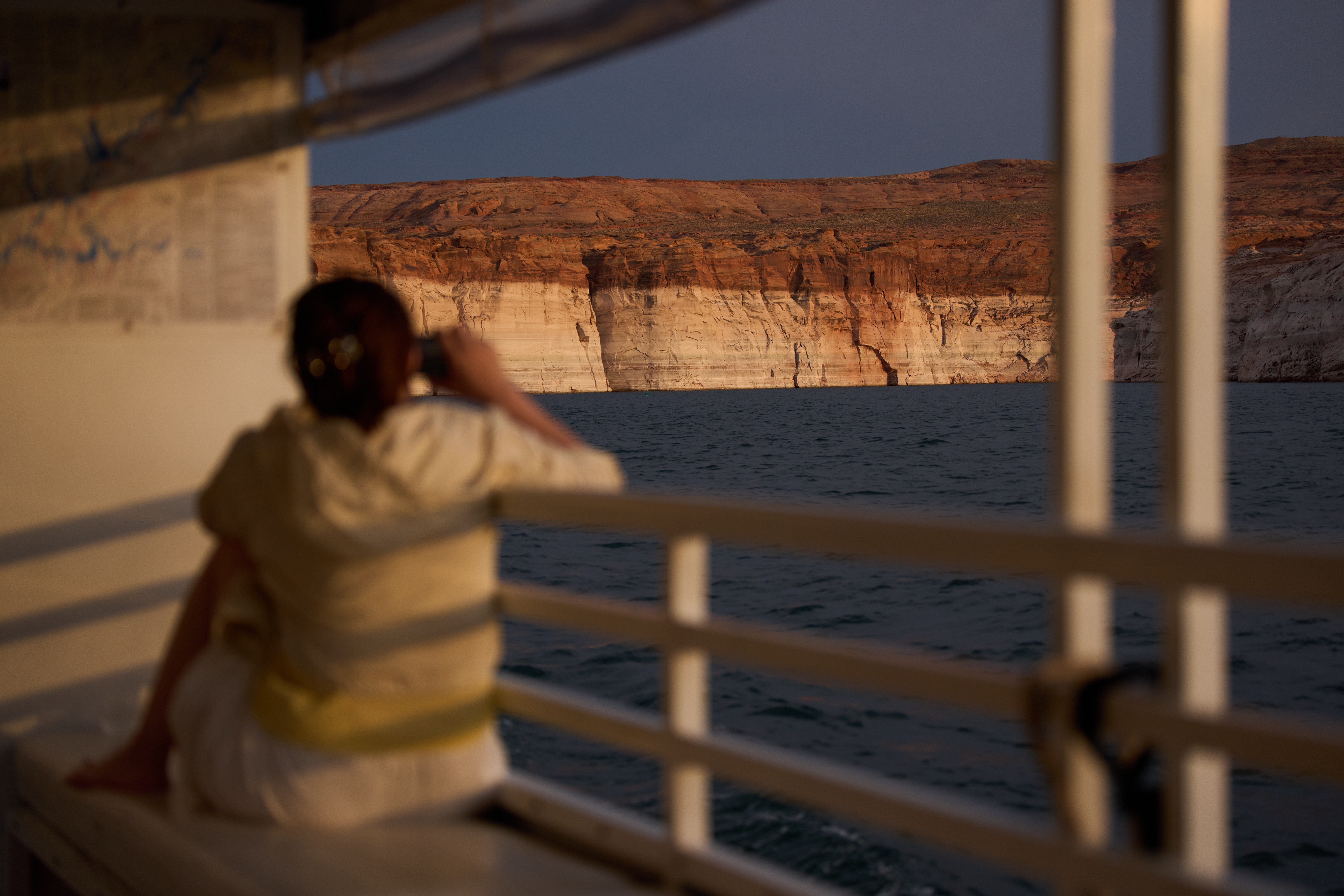 A person takes a picture while touring Lake Powell near Page, Arizona. A ring on the canyon wall shows how low water levels are. (John Locher/AP)