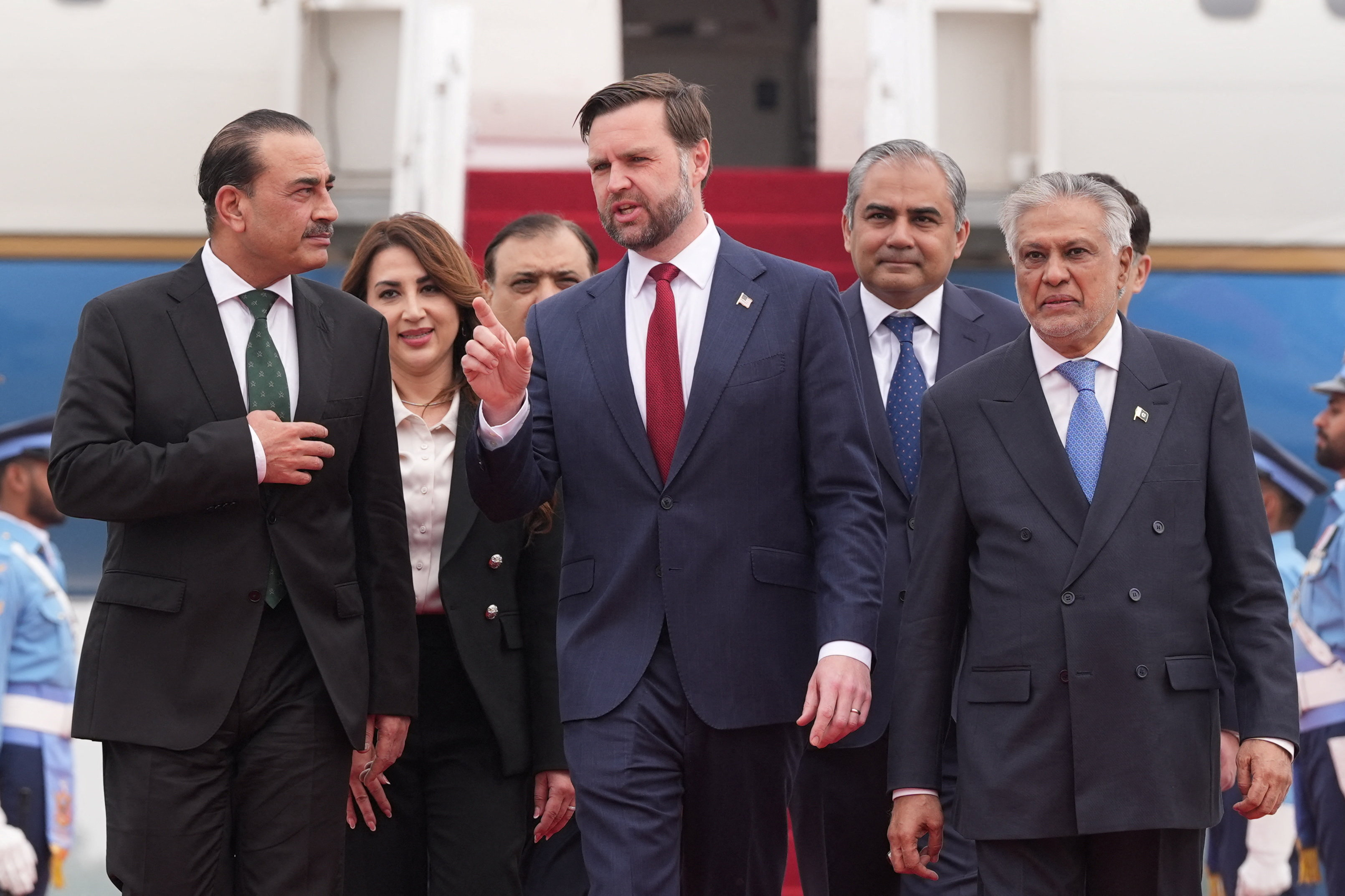 U.S. Vice President JD Vance walks with Pakistan's military chief Gen. Asim Munir, left, and Foreign Minister Mohammad Ishaq Dar after arriving for talks with Iranian officials in Islamabad on Saturday. (Jacquelyn Martin/Reuters)