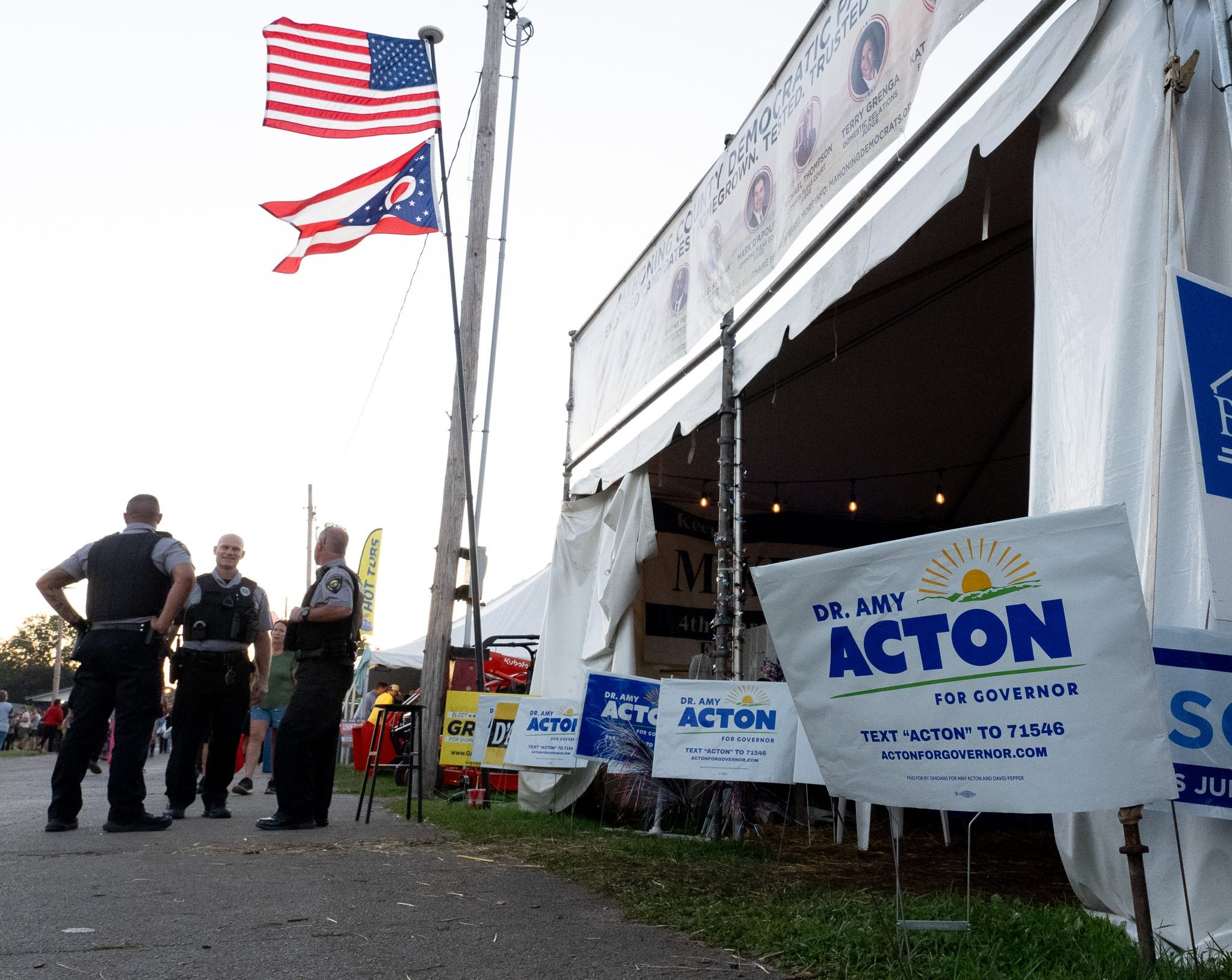 Police officers stand outside the tent at the Canfield Fair in Ohio where an armed man reportedly moved aggressively toward Democratic gubernatorial nominee Amy Acton on Sunday. (Lisa Scalfaro/USA Today Network/Reuters Connect)