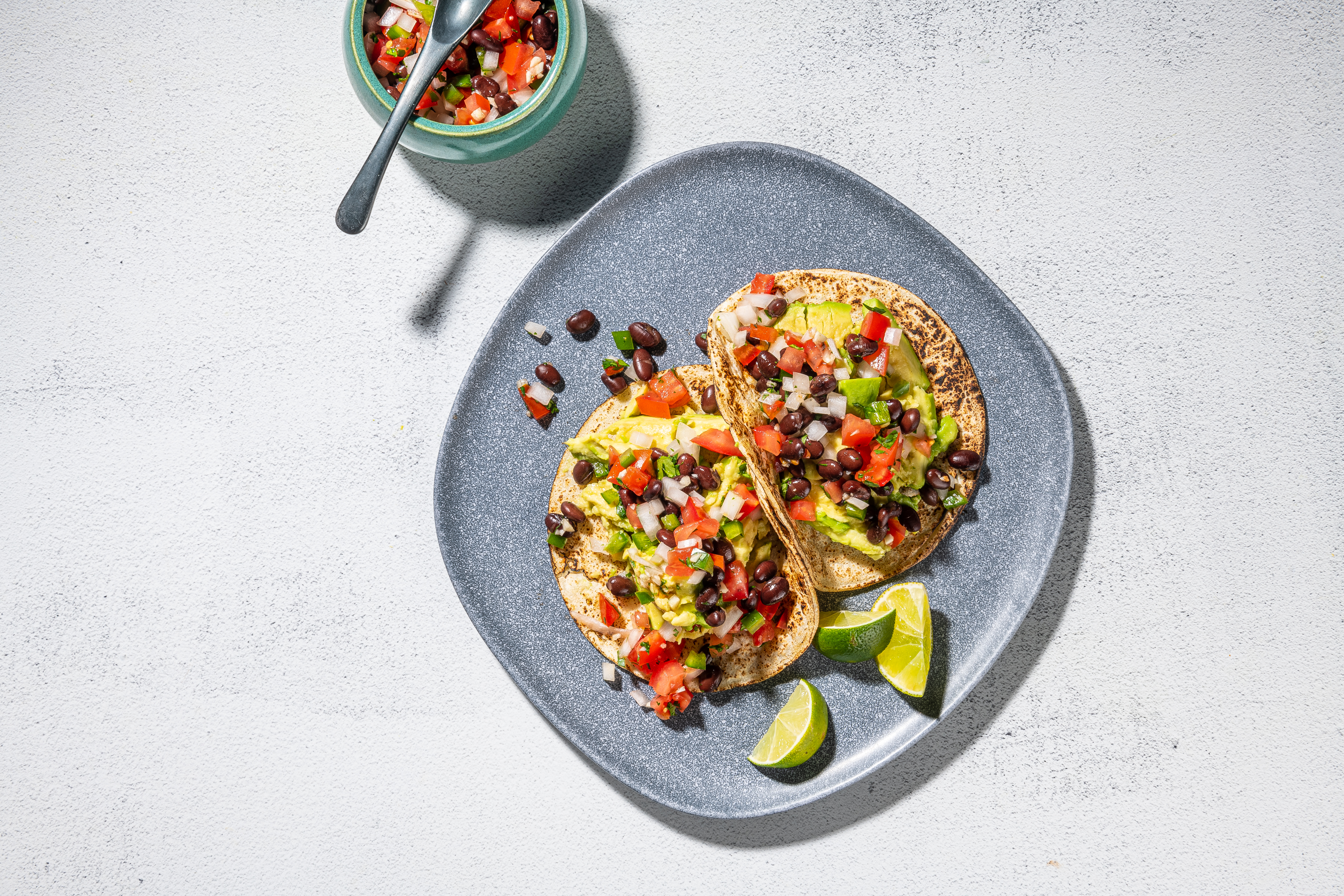 Tacos filled with avocado, black beans and pico de gallo are a great source of fiber. (Rey Lopez/For The Washington Post; food styling by Lisa Cherkasky)