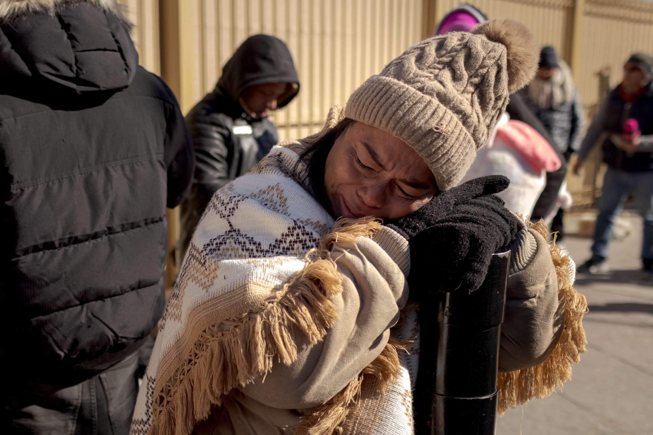 A woman standing on a border bridge in Ciudad Juárez, Mexico, reacts after learning that her appointment with immigration officers had been canceled in January 2025. (Anna Watts/For The Washington Post).
