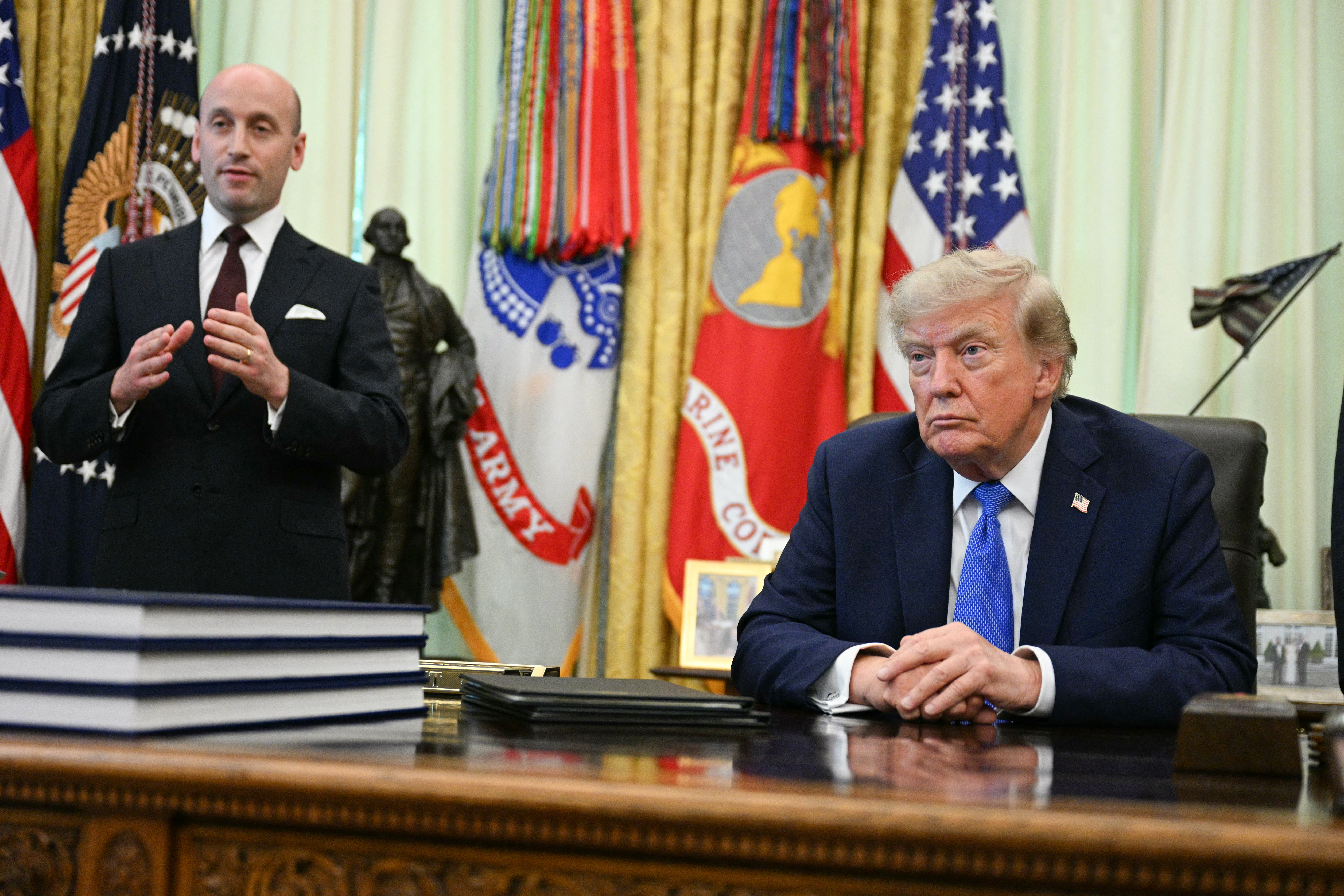 White House Deputy Chief of Staff Stephen Miller with President Donald Trump at the signing of the orders on Thursday. (Jim Watson/AFP/Getty Images)