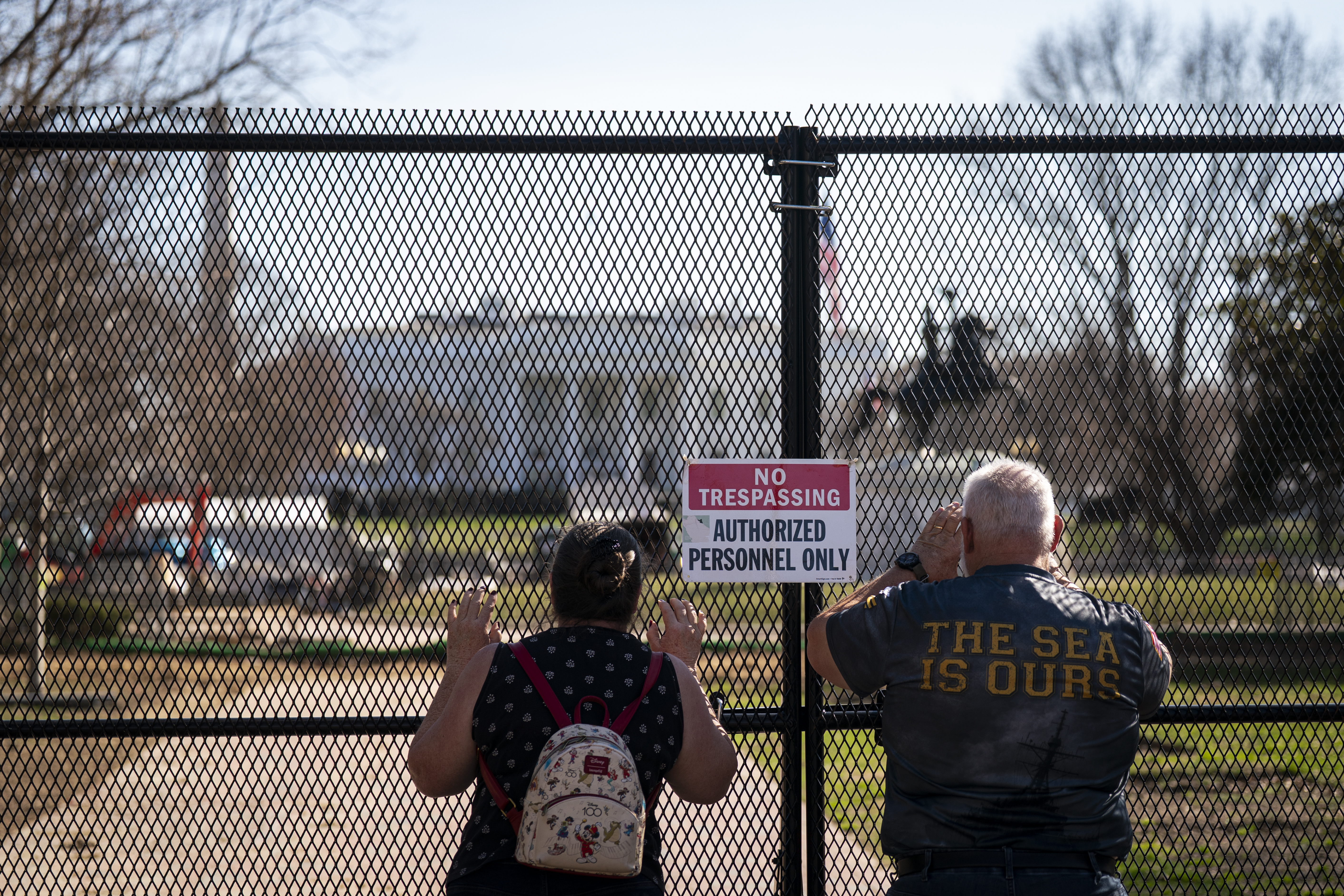 People watch construction work in Lafayette Park across from the White House in March. (Al Drago for The Post)
