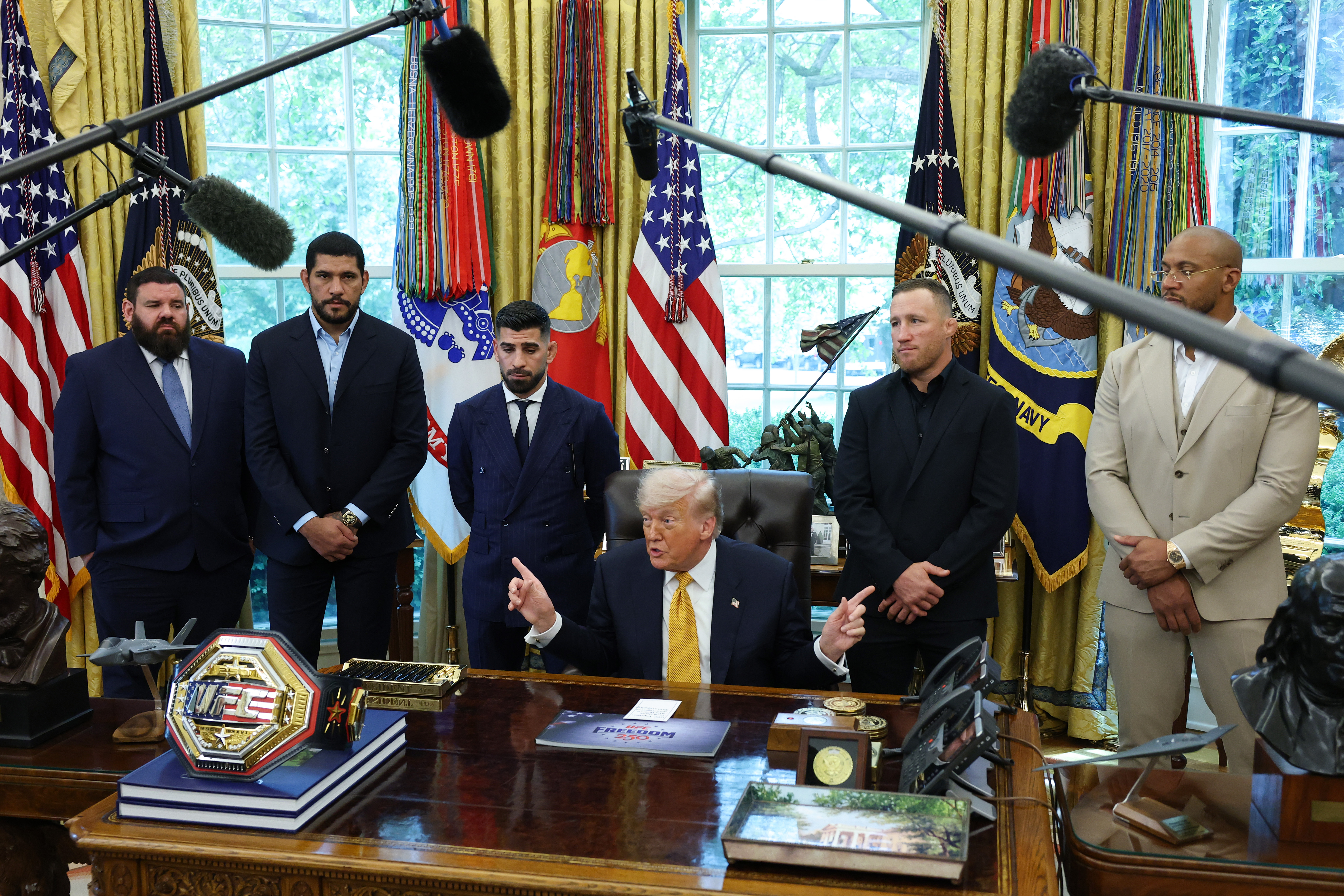 President Donald Trump speaks to reporters on Wednesday while flanked by UFC fighters. (Anna Moneymaker/Getty Images)