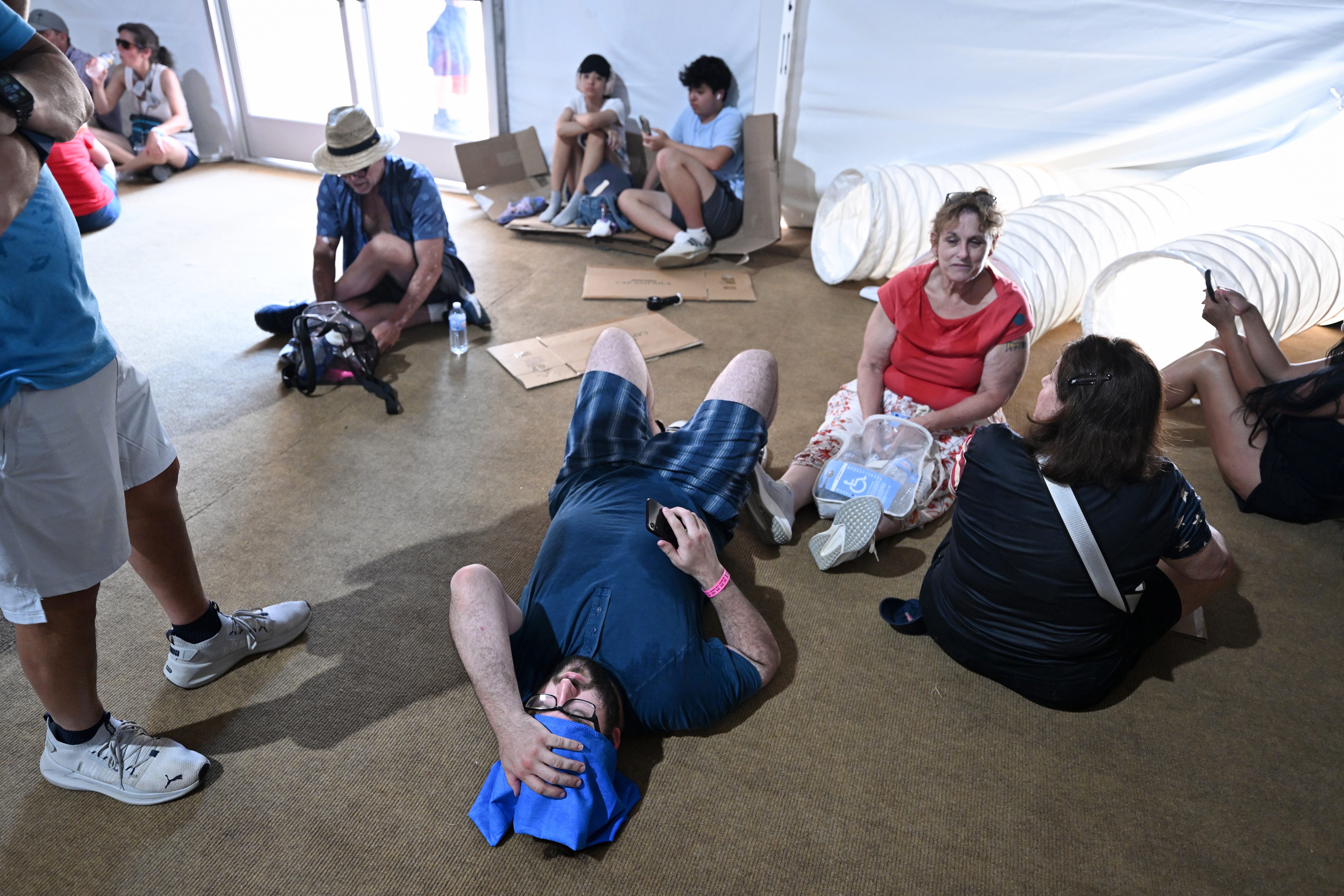 People try to cool off at the Great American State Fair along the National Mall on Friday. (Matt McClain/For The Washington Post)