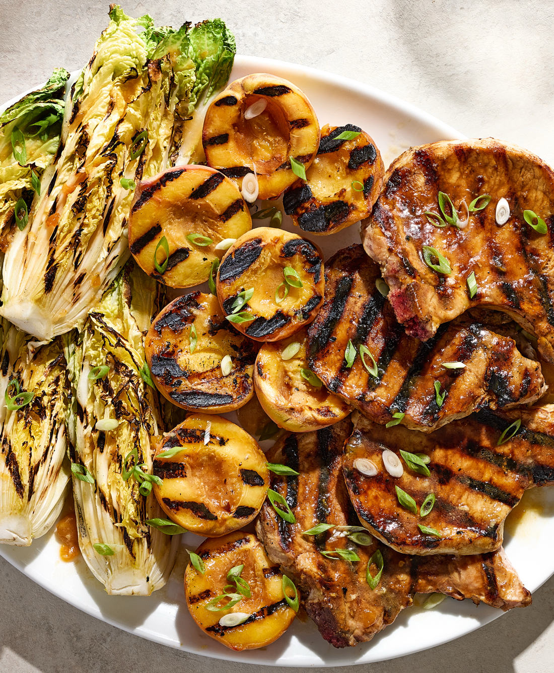Apricot-Glazed Pork Chops With Grilled Peaches and Napa Cabbage.