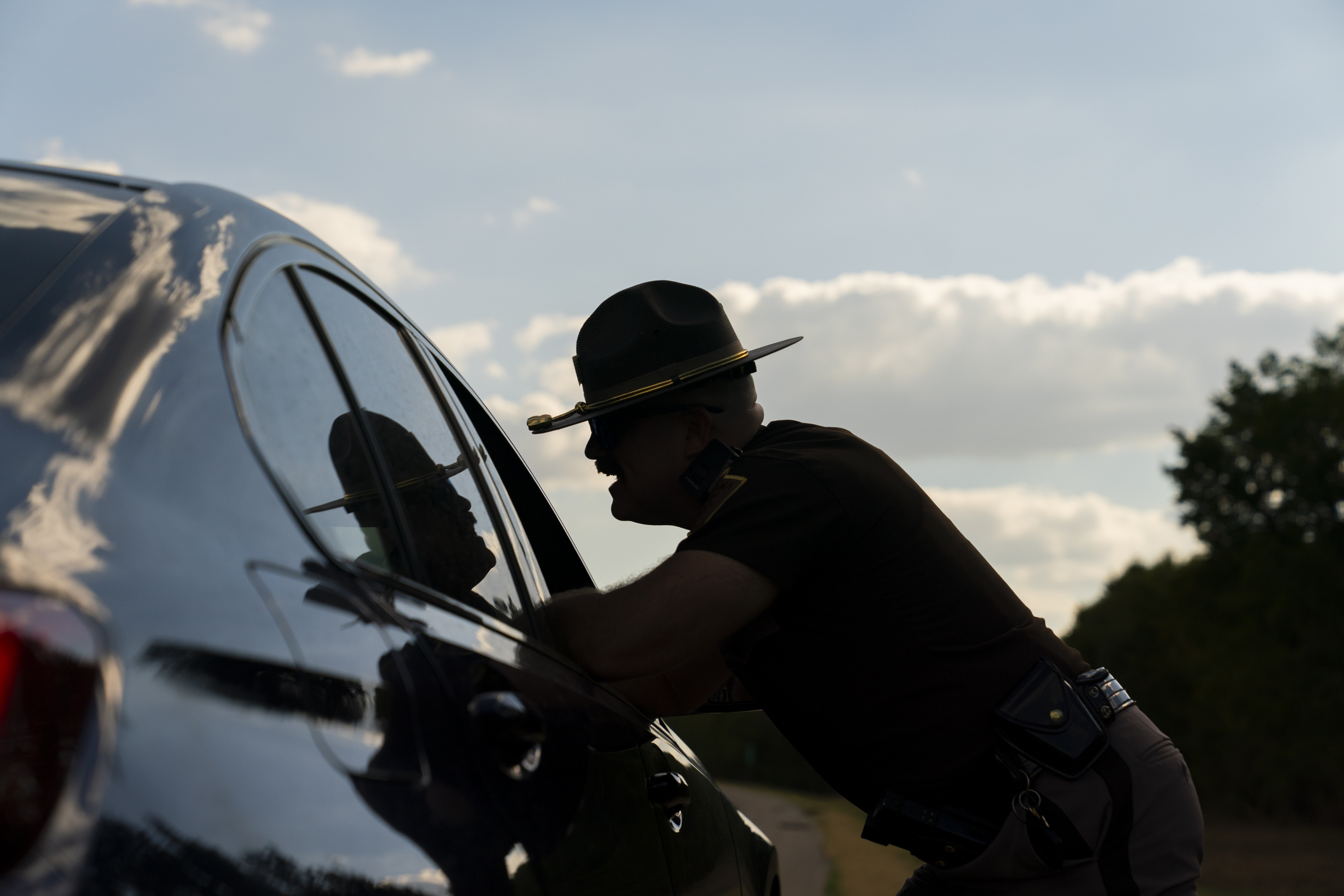 An Oklahoma Highway Patrol trooper talks with a motorist who was pulled over for speeding. (Nick Oxford/For The Washington Post)