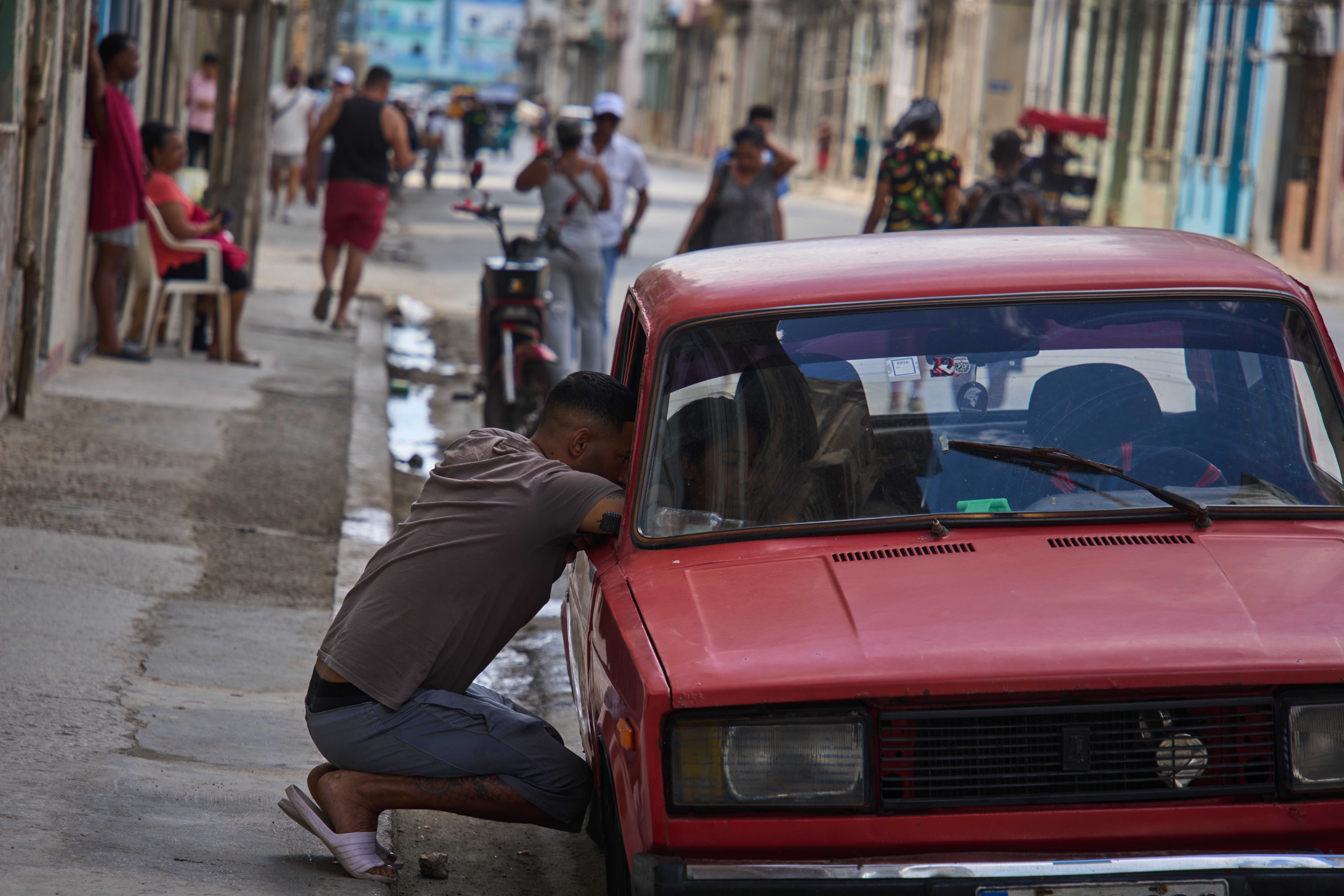 A man speaks with a person in a car during a blackout in Havana on Monday. (Ramon Espinosa/AP)