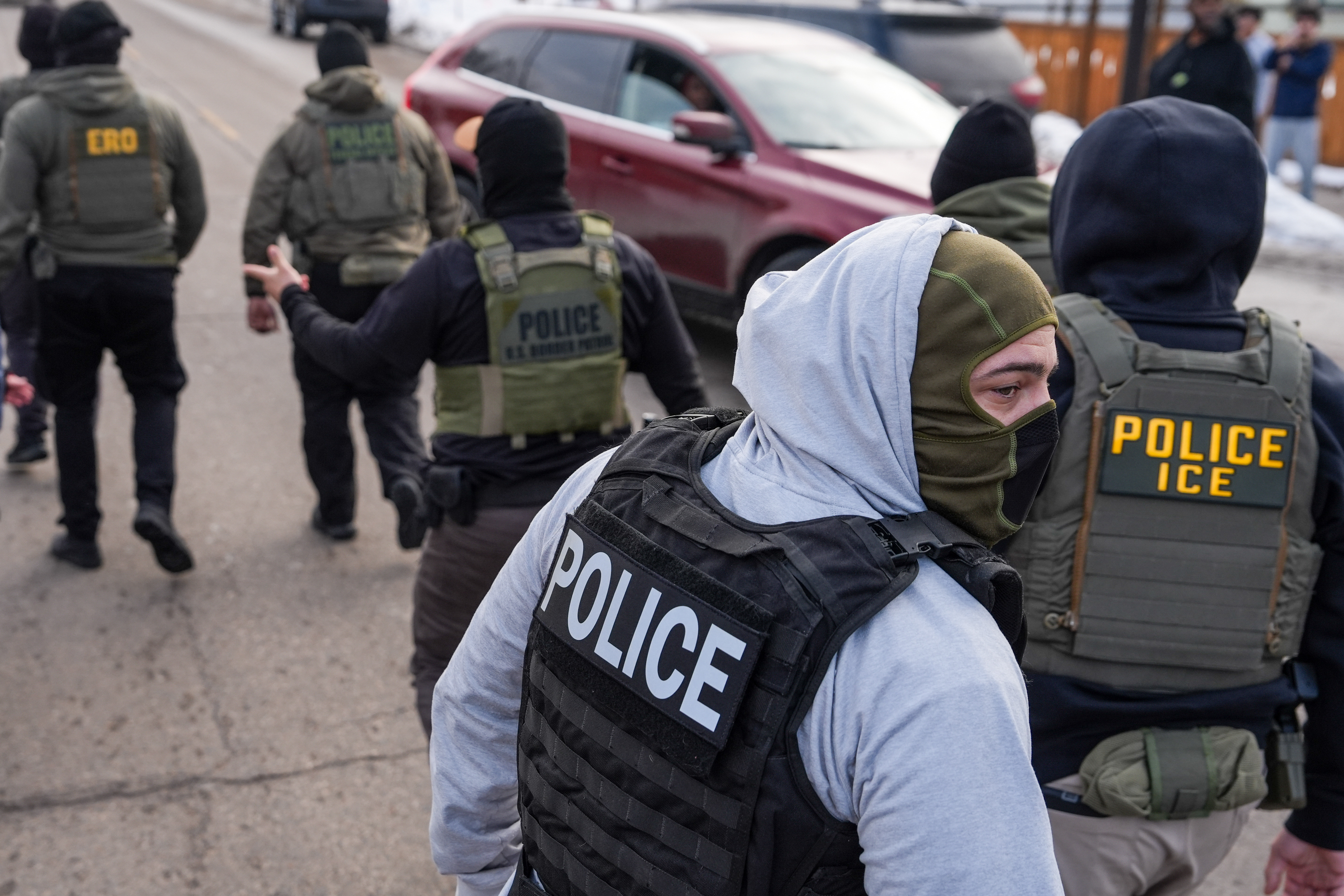 Federal agents conduct immigration enforcement operations in February in Minneapolis. (Ryan Murphy/AP)
