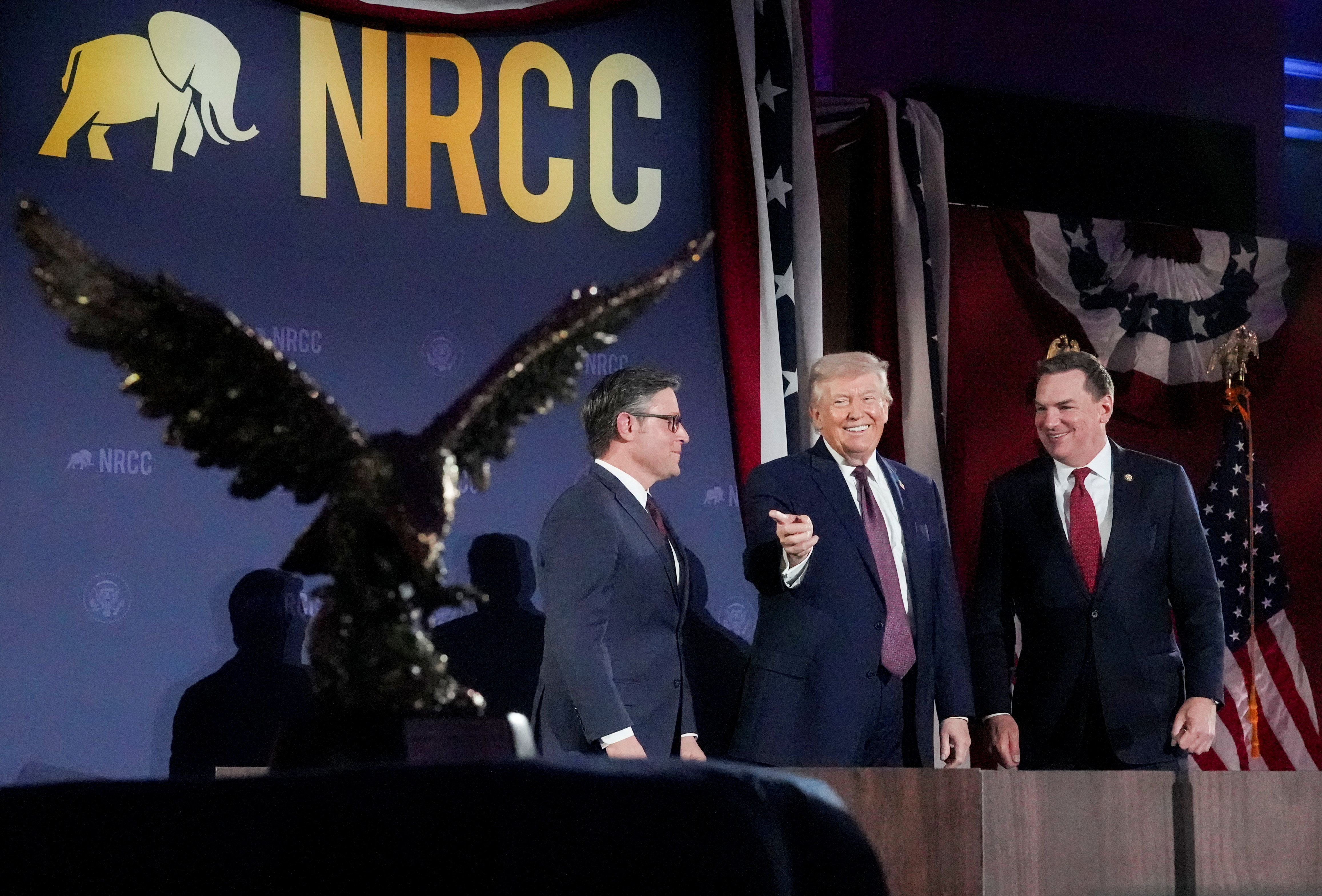 President Donald Trump, House Speaker Mike Johnson (R-Louisiana) and Rep. Richard Hudson (R-North Carolina), chairman of the National Republican Congressional Committee, attend the NRCC annual fundraising dinner on March 25. (Ken Cedeno/Reuters)