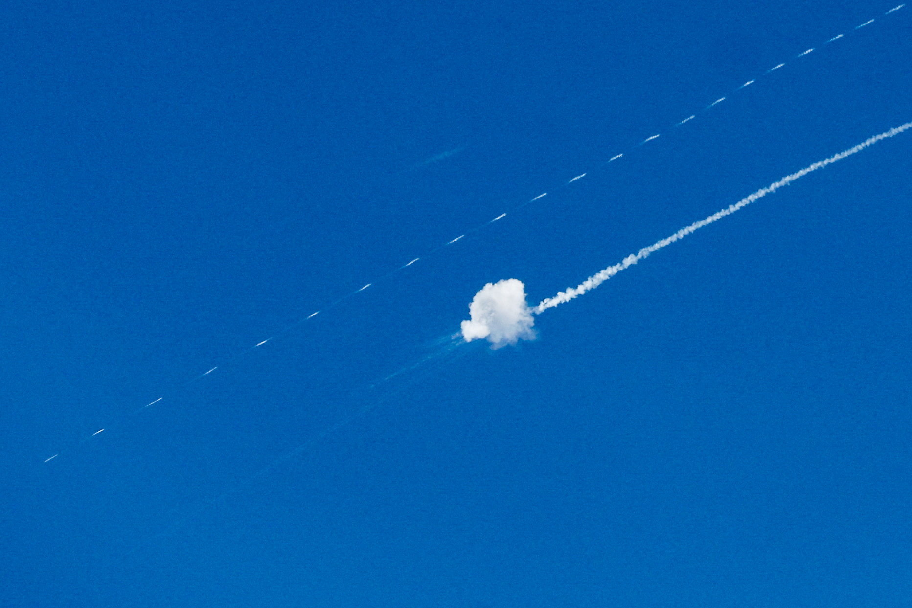 An Israeli air defense system intercepts an Iranian missile flying toward Israel on Monday. (Mussa Qawasma/Reuters)