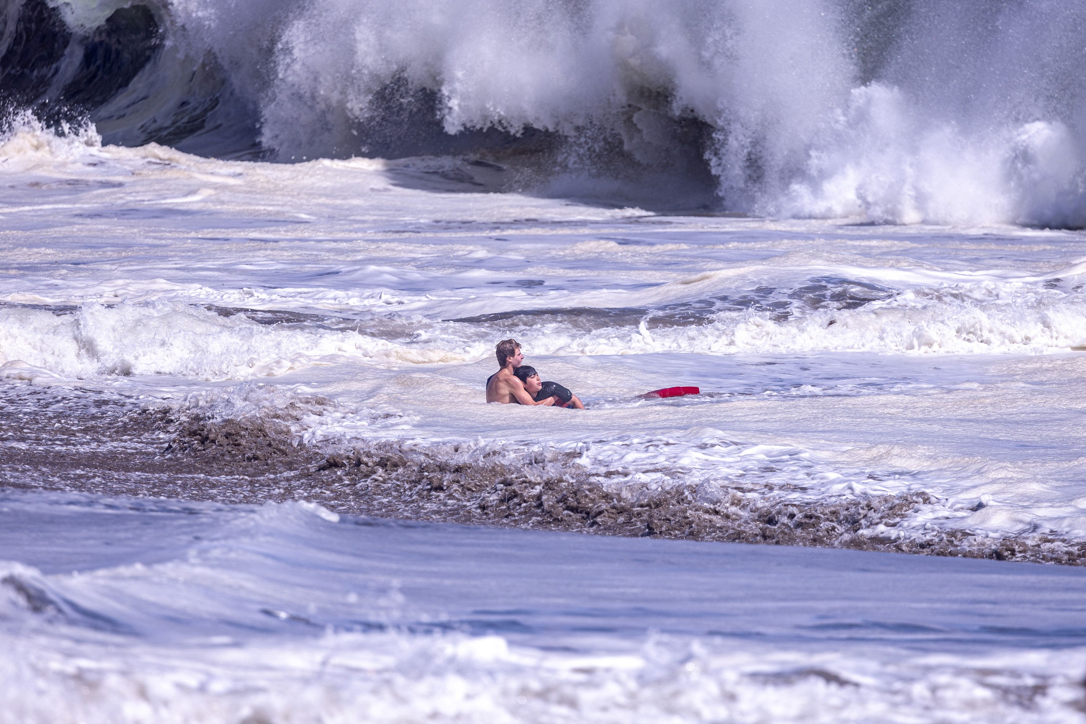 A lifeguard rescues a boy at Seabright Beach in Santa Cruz, California, on Saturday. (Scott Vander Dussen)