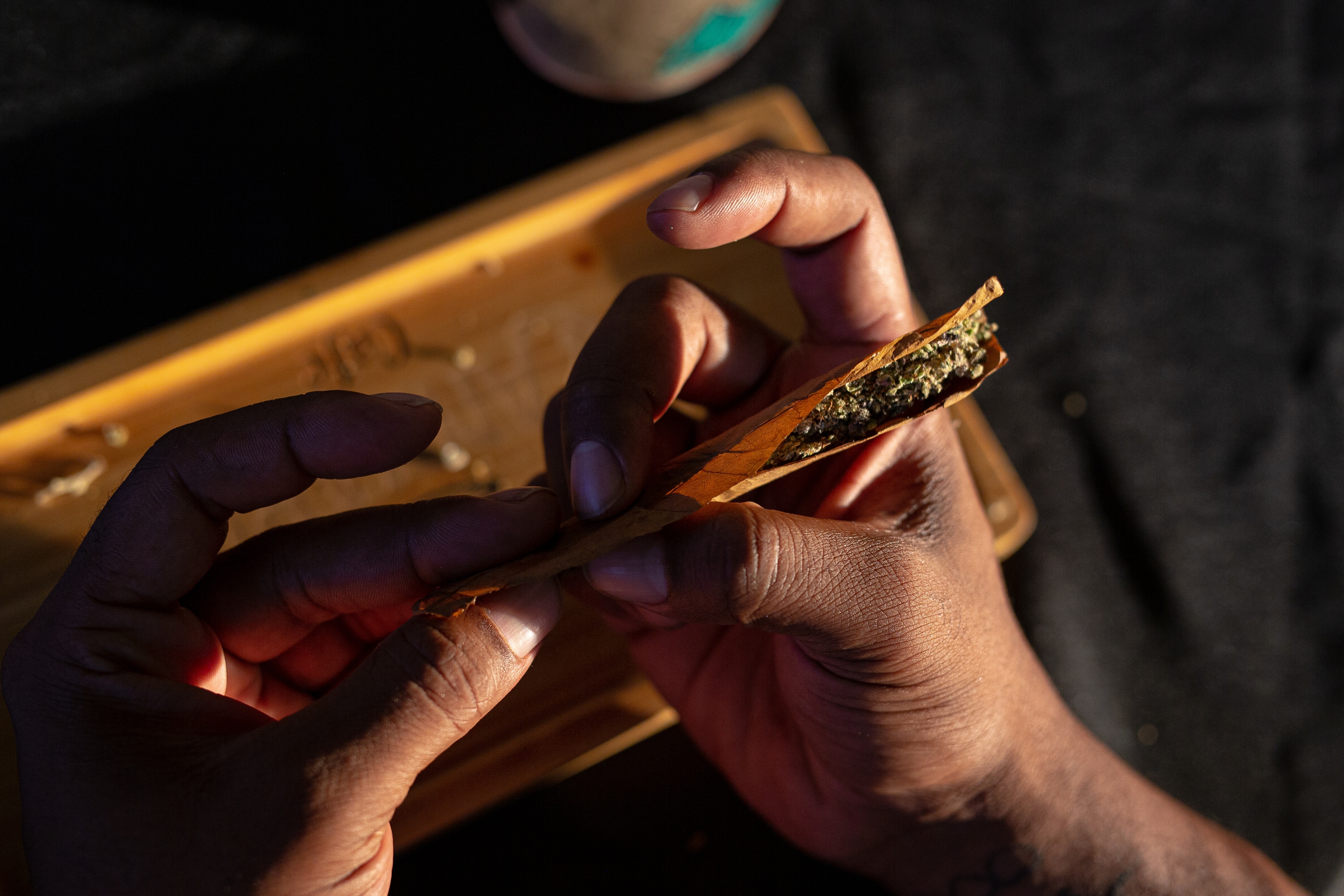 A person rolls a cannabis blunt in Chesapeake, Virginia, in 2022. (Parker Michels-Boyce/For The Washington Post)