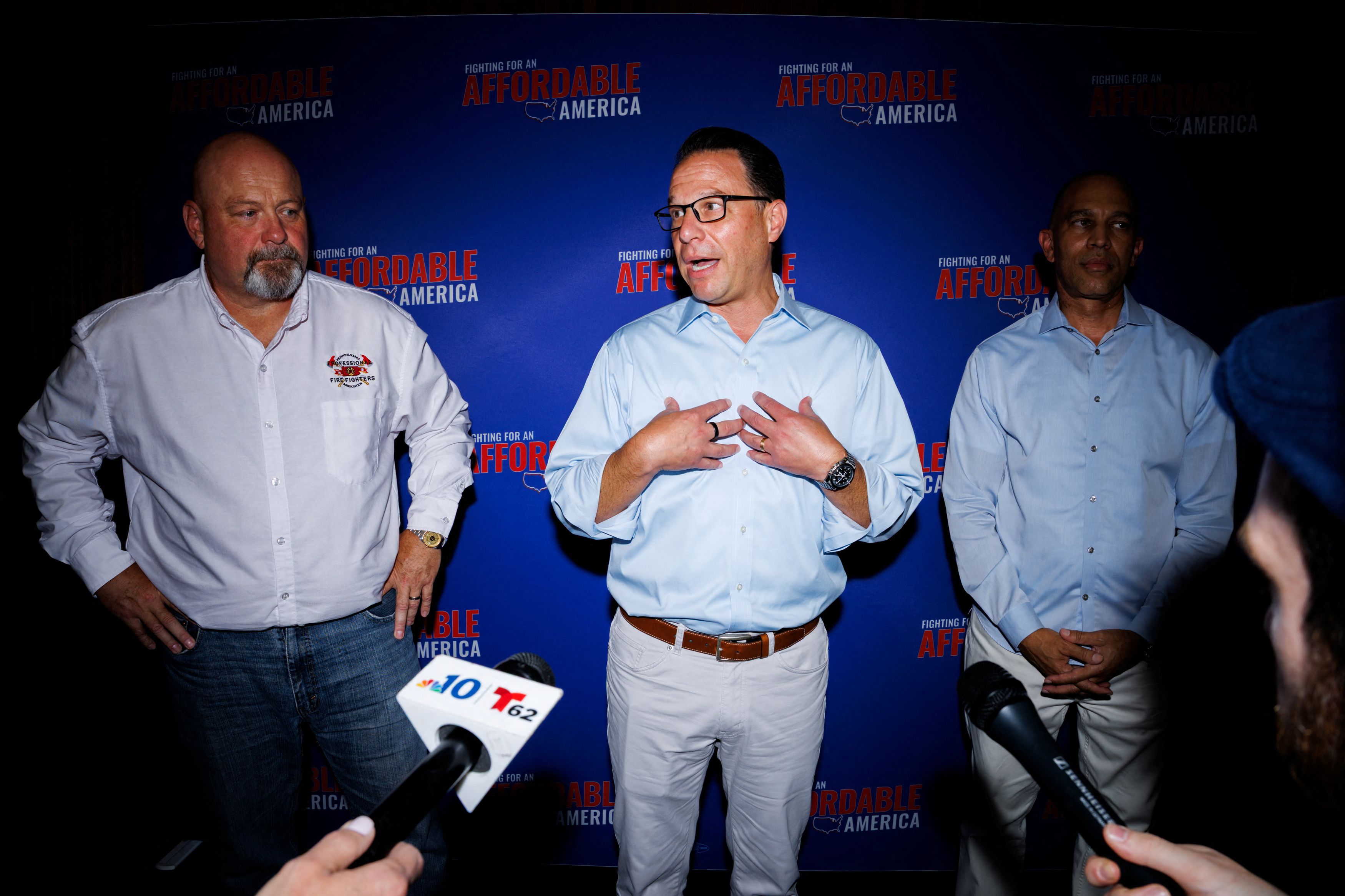 Pennsylvania Gov. Josh Shapiro (D) this week with Bob Brooks, left, a congressional candidate in Pennsylvania, and House Minority Leader Hakeen Jeffries (D-New York) at a midterm elections event. (Hannah Beier/Reuters)