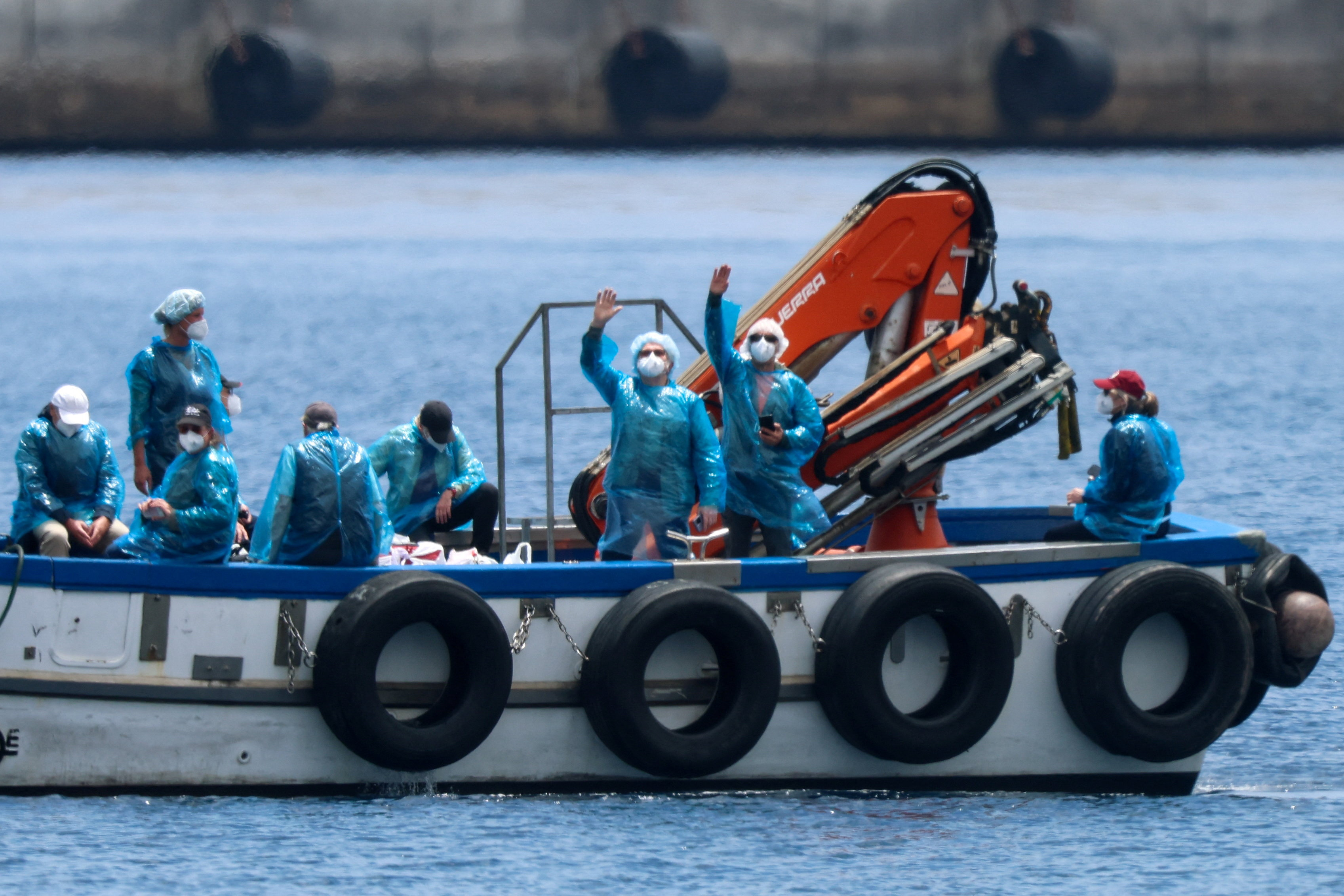 Passengers from the Hondius cruise ship are transferred by boat Sunday to the port of Granadilla de Abona in Tenerife in Spain's Canary Islands. (Hannah McKay/Reuters)