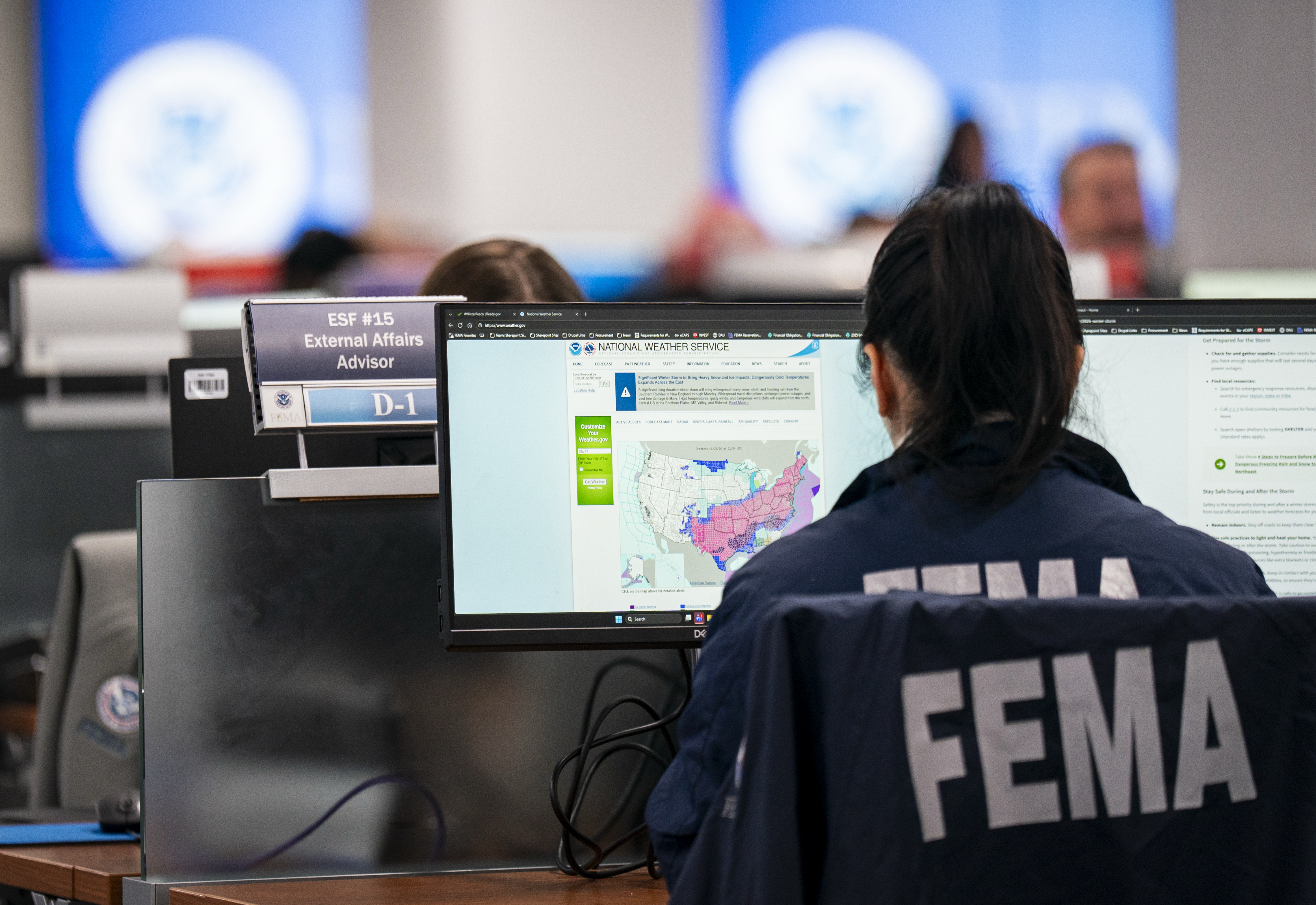 A National Response Coordination Center employee looks at a map of an approaching winter storm this past January at the Federal Emergency Management Agency headquarters in Washington. (Al Drago/Getty Images)