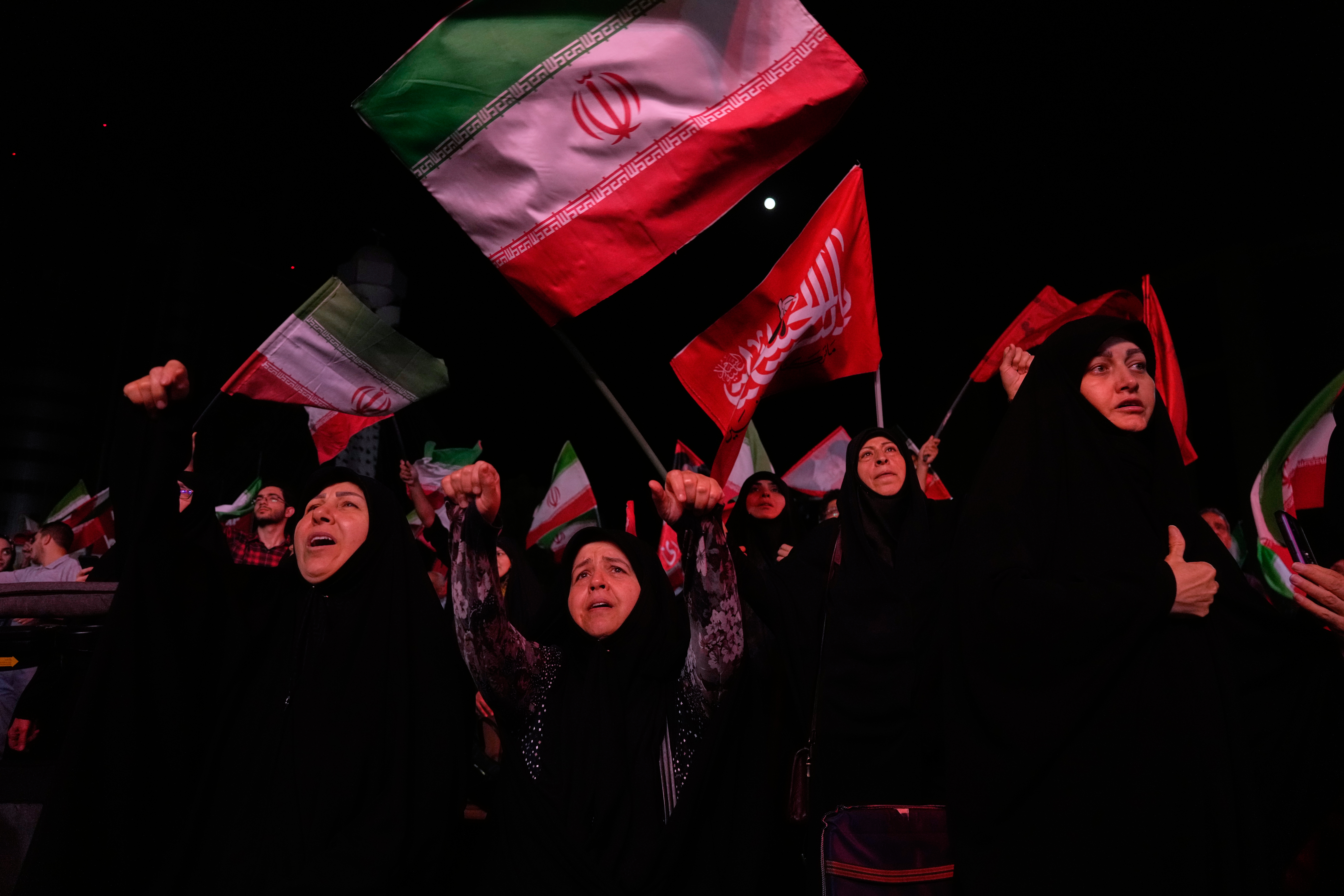 Pro-government demonstrators chant at a gathering in Tehran on Tuesday. (Vahid Salemi/AP)