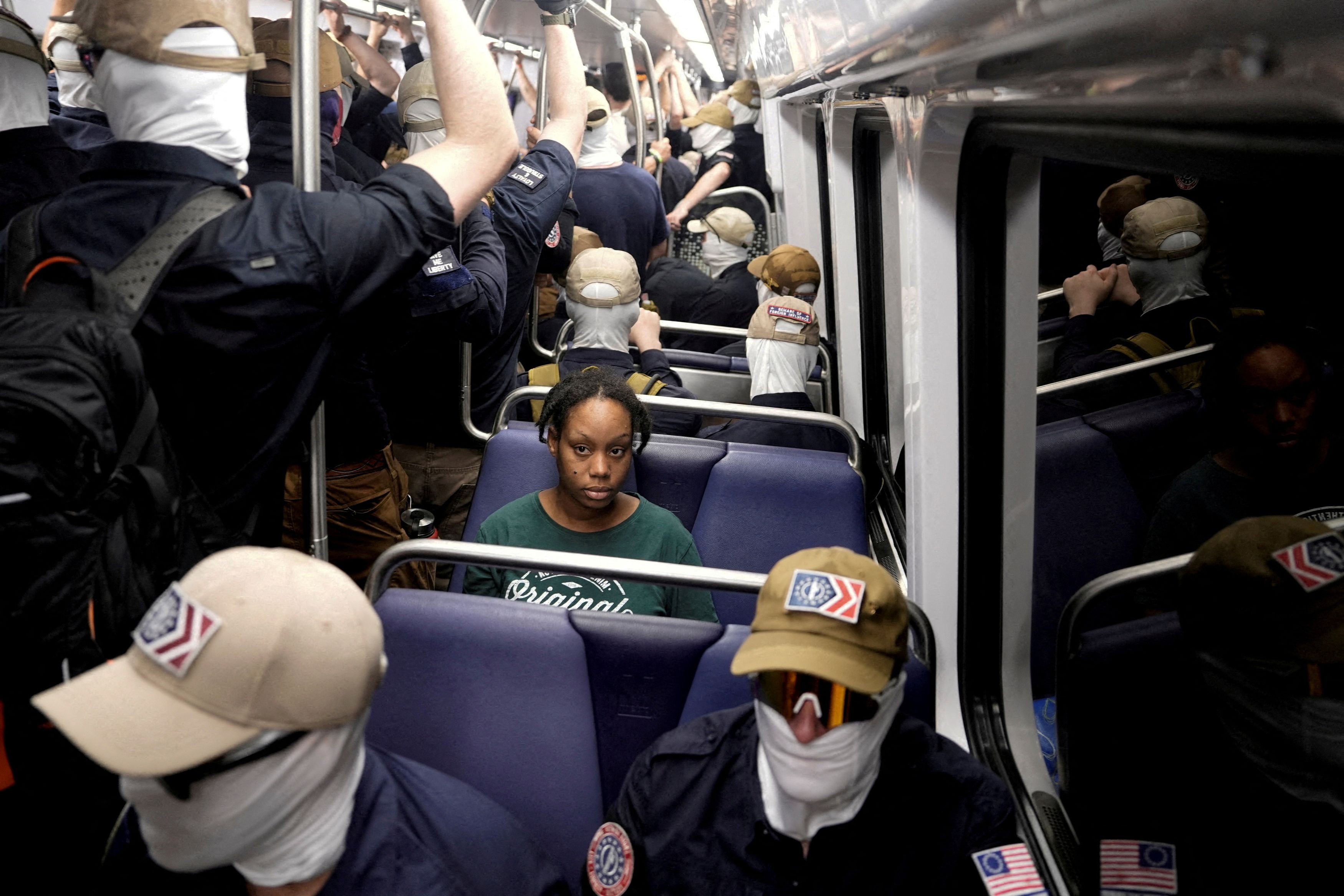The photo of Bernita Bowlding sitting in a Metro train filled with masked members of Patriot Front on July 4 has provoked widespread commentary. (Cheney Orr/Reuters)