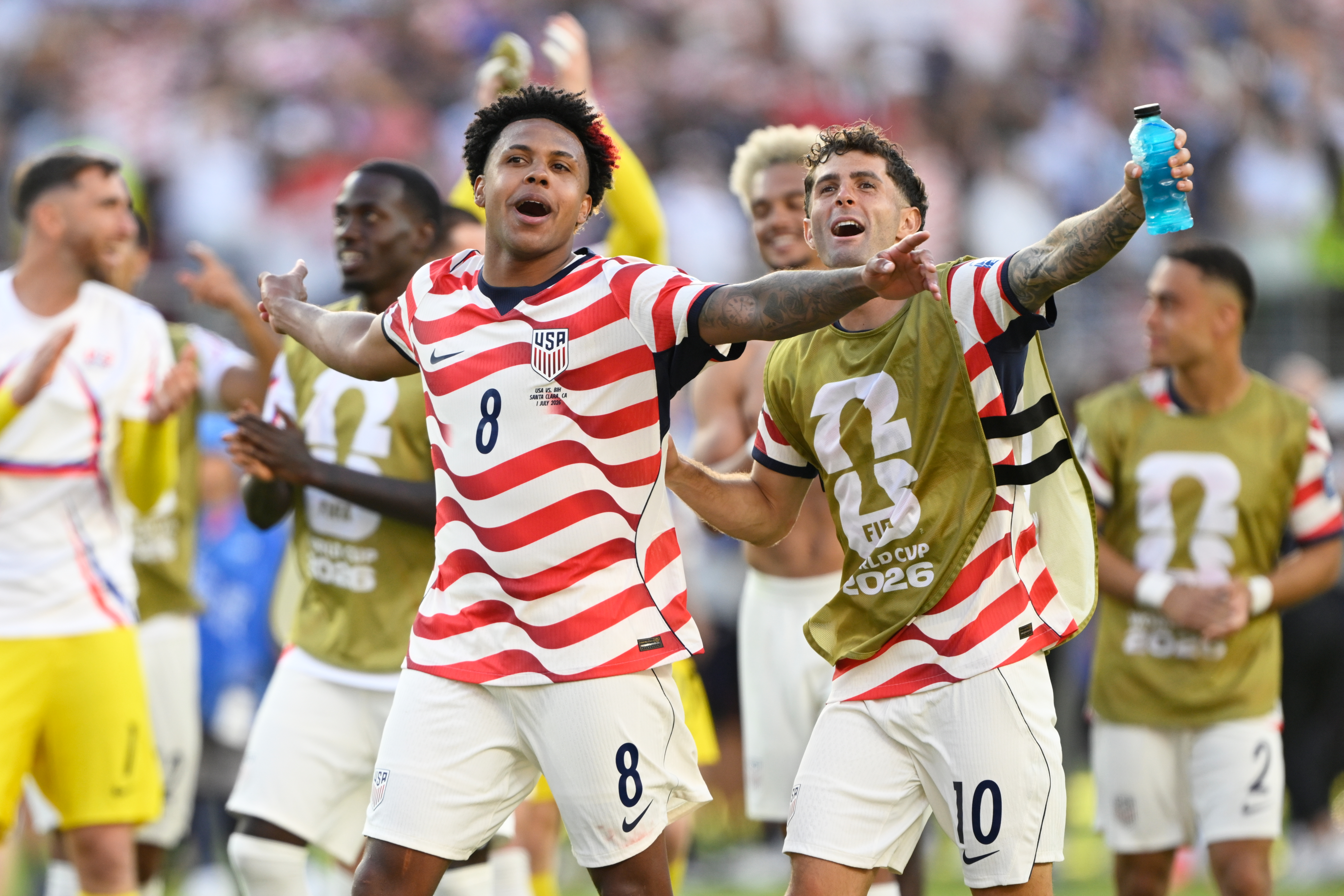 Weston McKennie, left, and Christian Pulisic celebrate the U.S. team's round-of-32 win against Bosnia on Wednesday. (Eakin Howard/AP)