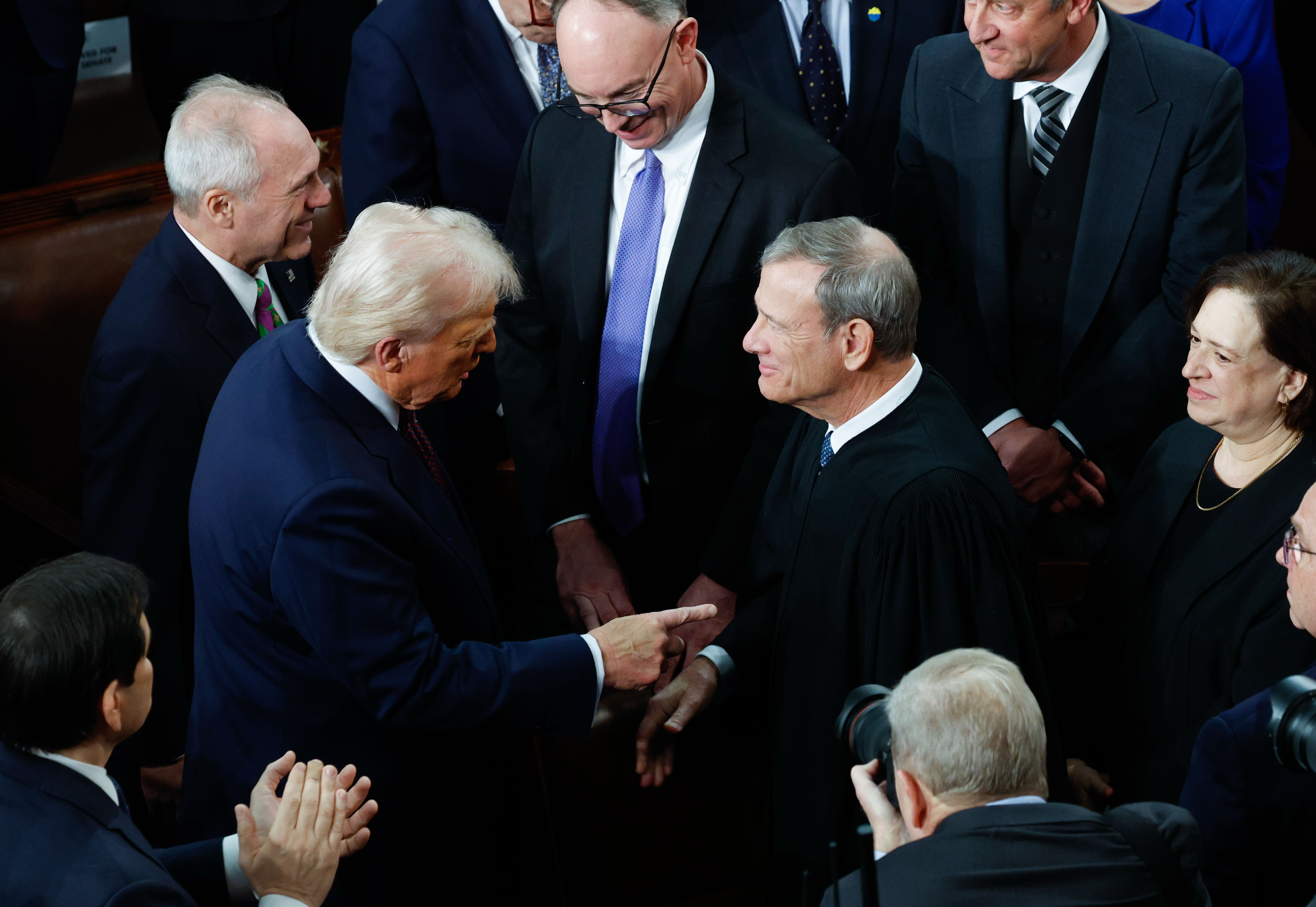 President Donald Trump greets Chief Justice John G. Roberts Jr. before addressing a joint session of Congress on March 4, 2025. (Tom Brenner/For The Washington Post)