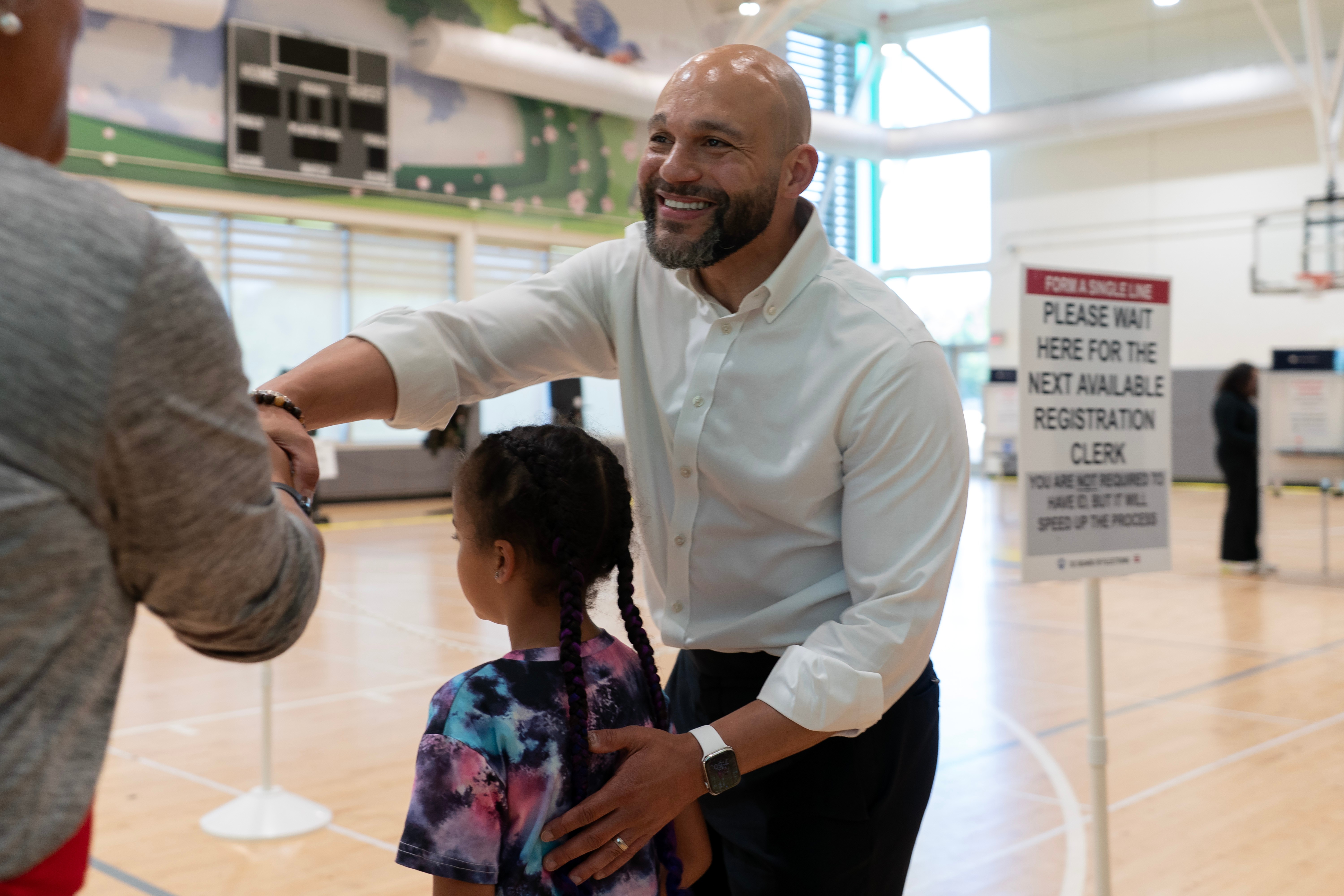 D.C. Council member Robert White Jr. shakes hands with supporters as he arrives to cast his vote on Tuesday. (Jose Luis Magana/AP Photo/Jose Luis Magana)
