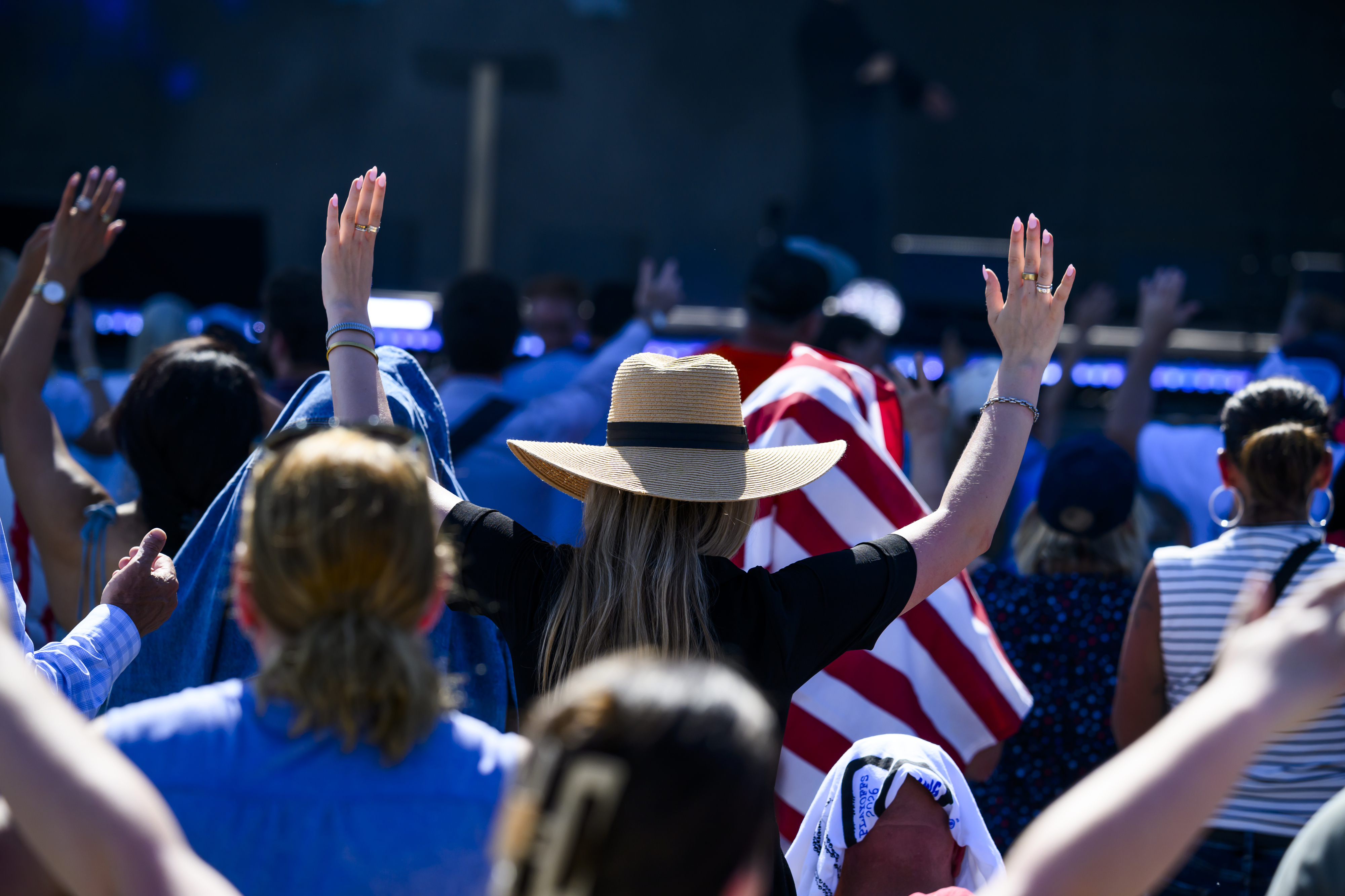 People raise their hands in prayer during an event on the National Mall in May. (Pete Kiehart/For The Washington Post)