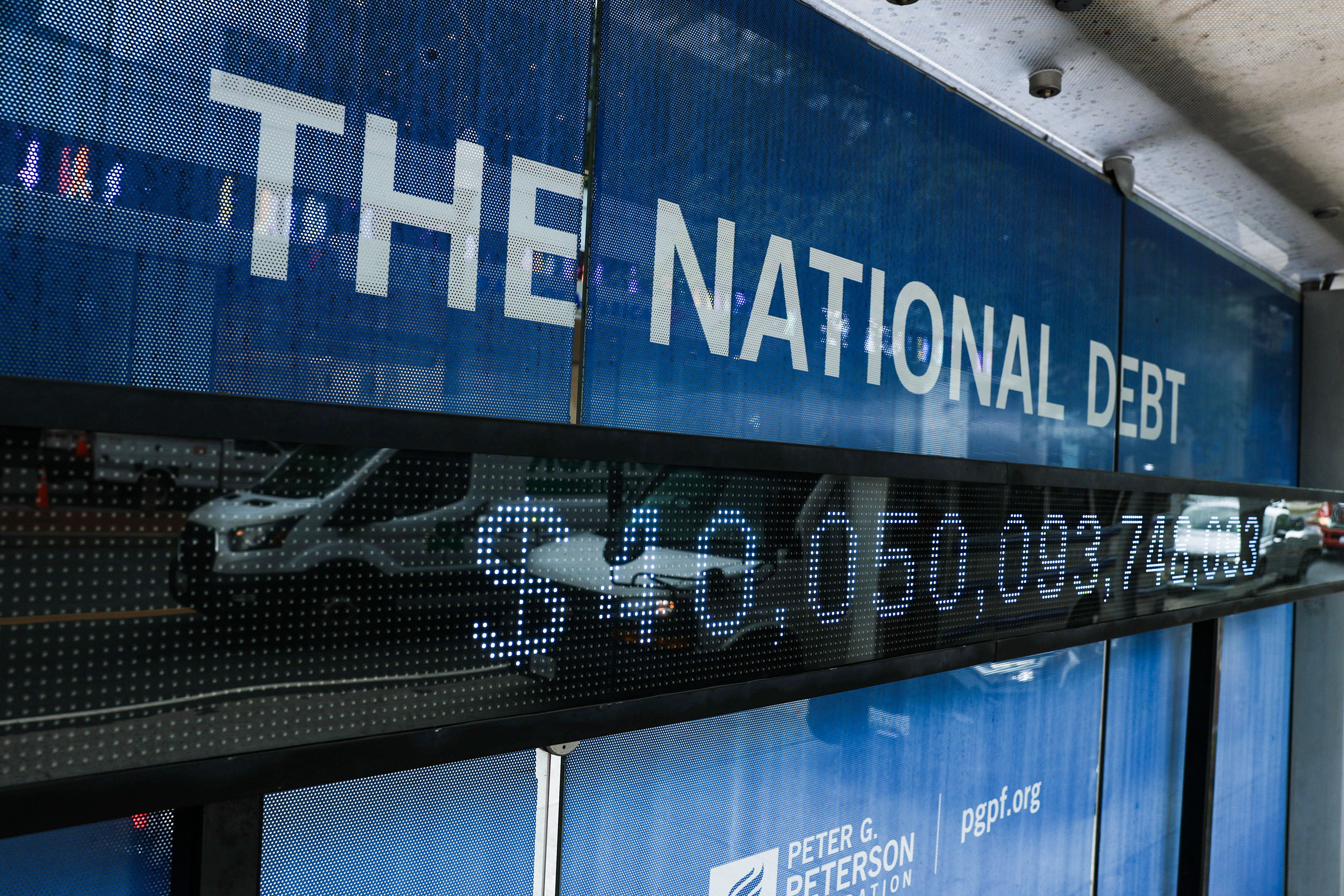 A sign at a Washington, D.C., bus stop displays the national debt. (Anna Moneymaker/Getty Images)