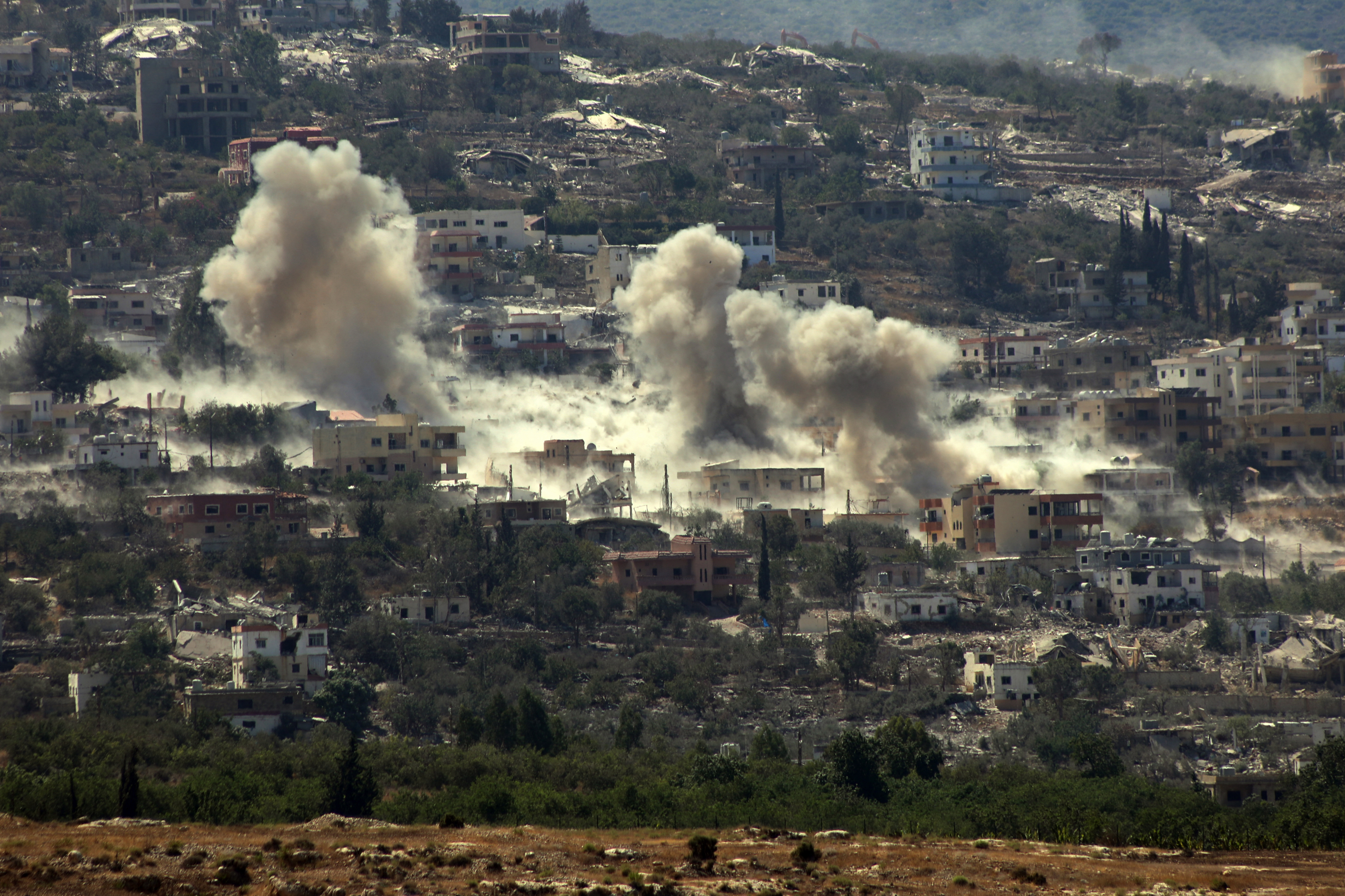 Smoke rises from the site of an Israeli controlled explosion near al-Mansouri, Lebanon, on Tuesday. (Kawnat Haju/AFP/Getty Images)