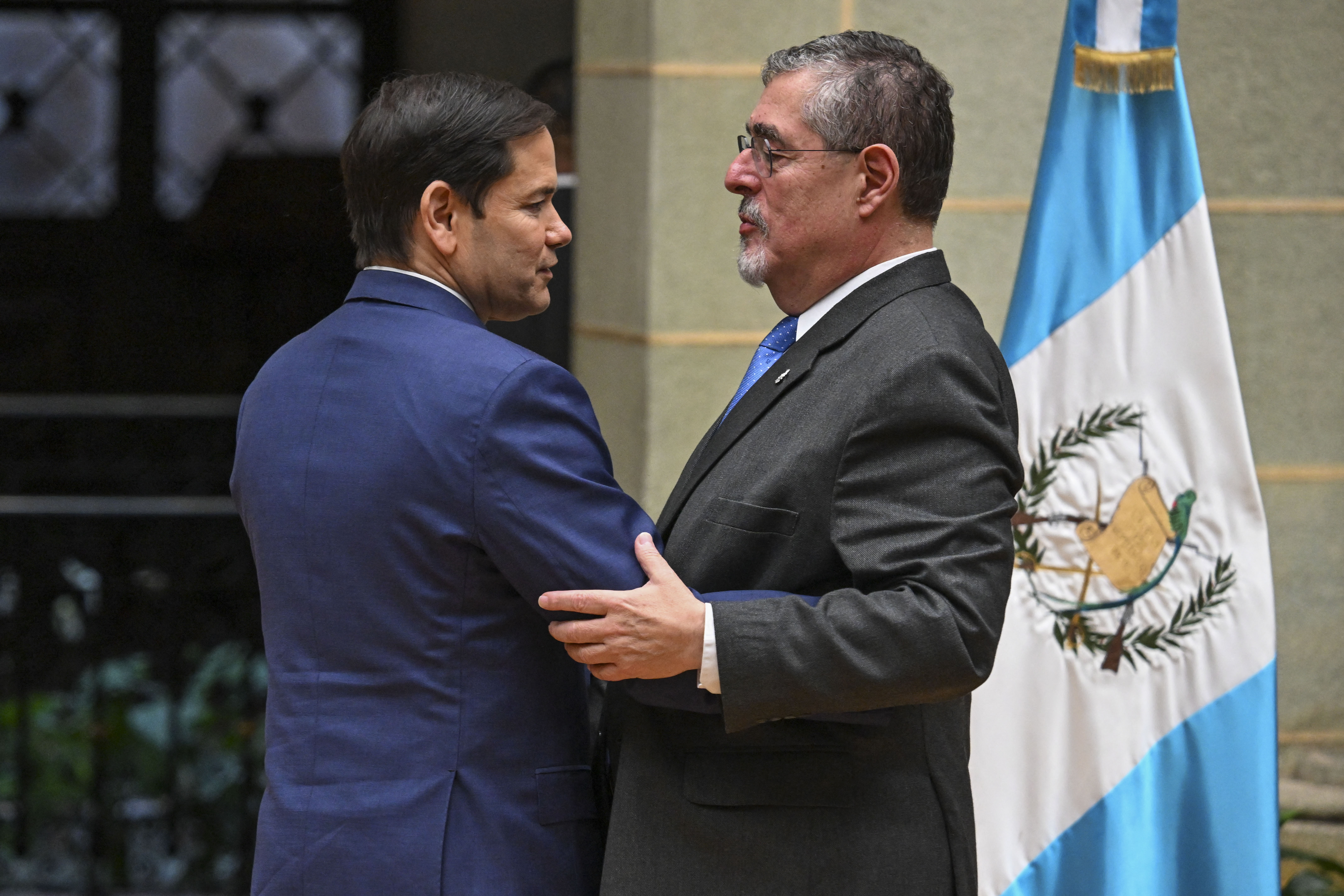 Secretary of State Marco Rubio, left, embraces Guatemalan President Bernardo Arévalo during a visit in February 2025. (Johan Ordonez/AFP/Getty Images)