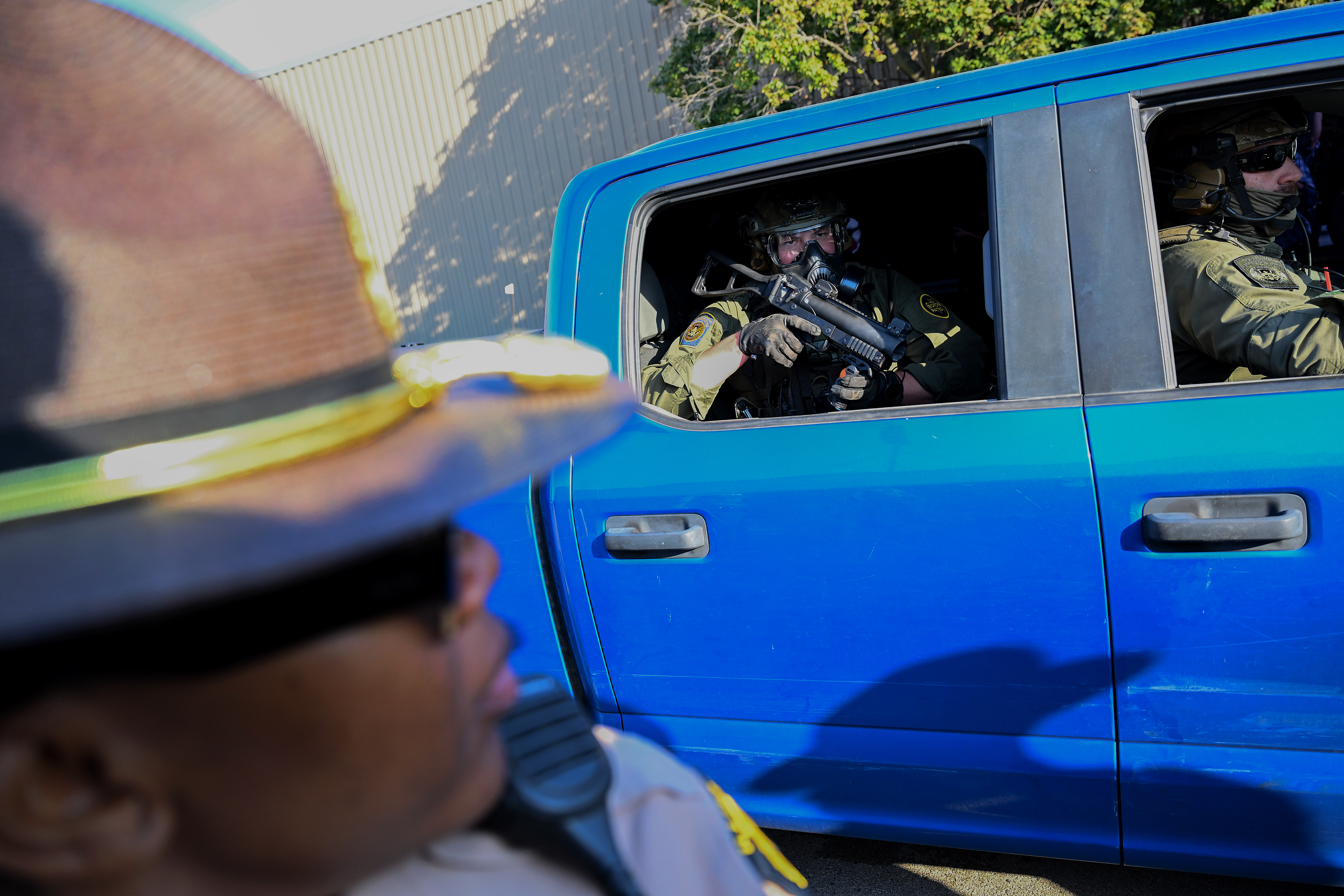Federal agents in a pickup truck guard a U.S. Immigration and Customs Enforcement facility last year in Broadview, Illinois. (Joshua Lott/The Washington Post)