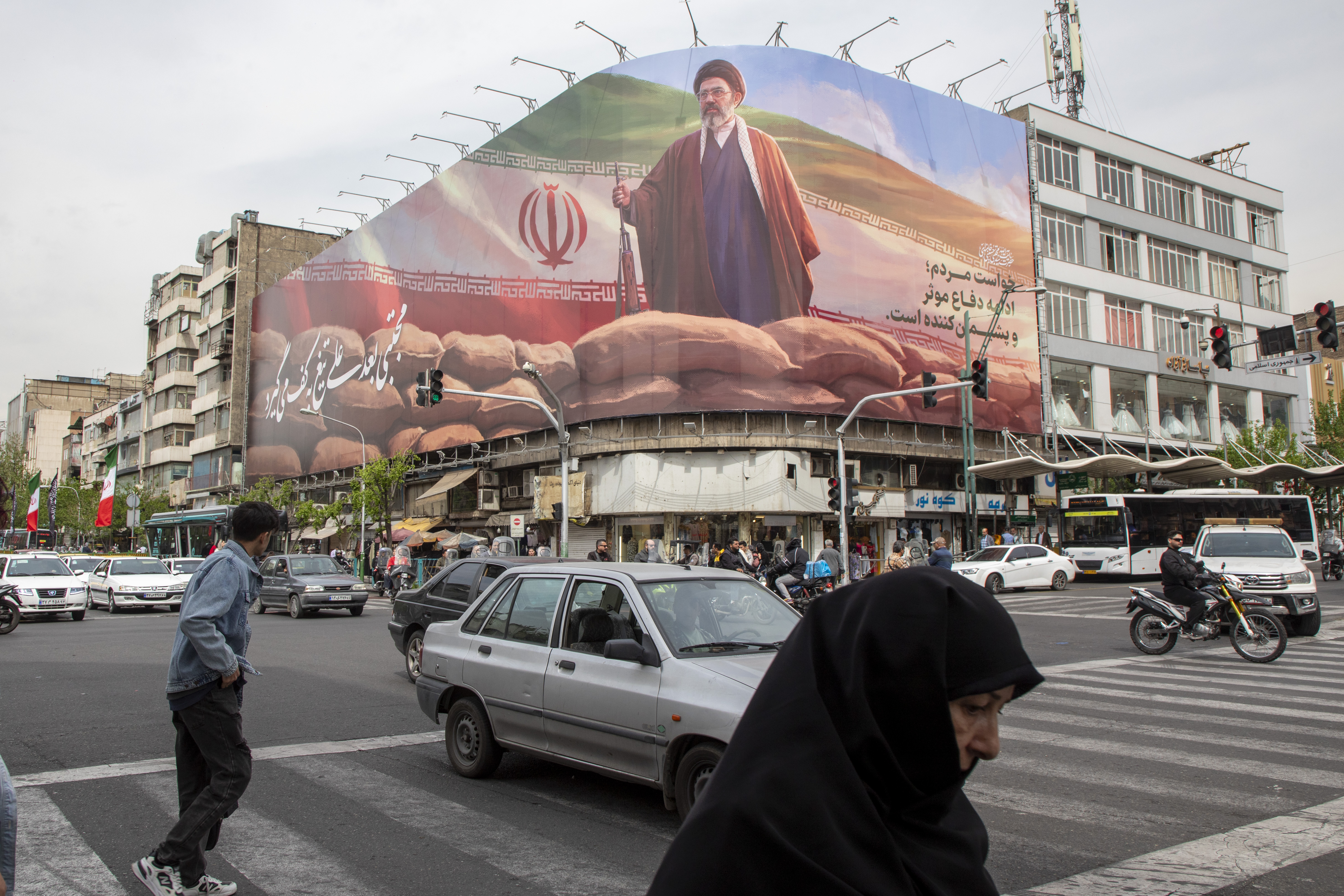 A banner featuring Ayatollah Mojtaba Khamenei, Iran's new supreme leader, overlooks a busy intersection in Tehran. (Majid Saeedi/Getty Images)