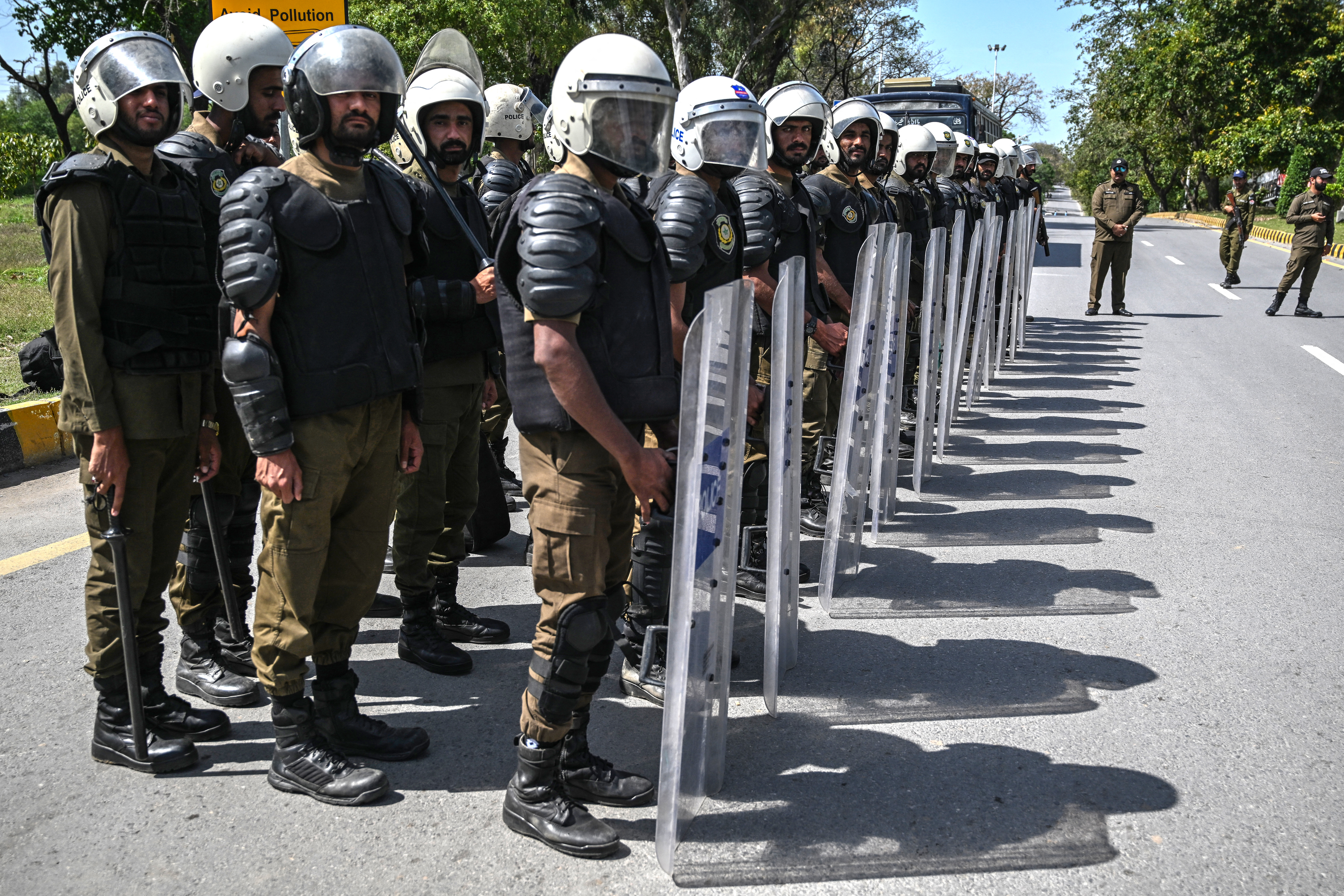 Riot police line up along a road near the expected venue of the U.S.-Iran talks in the governmental Red Zone of Islamabad on Friday. (Aamir Qureshi/AFP/Getty Images)