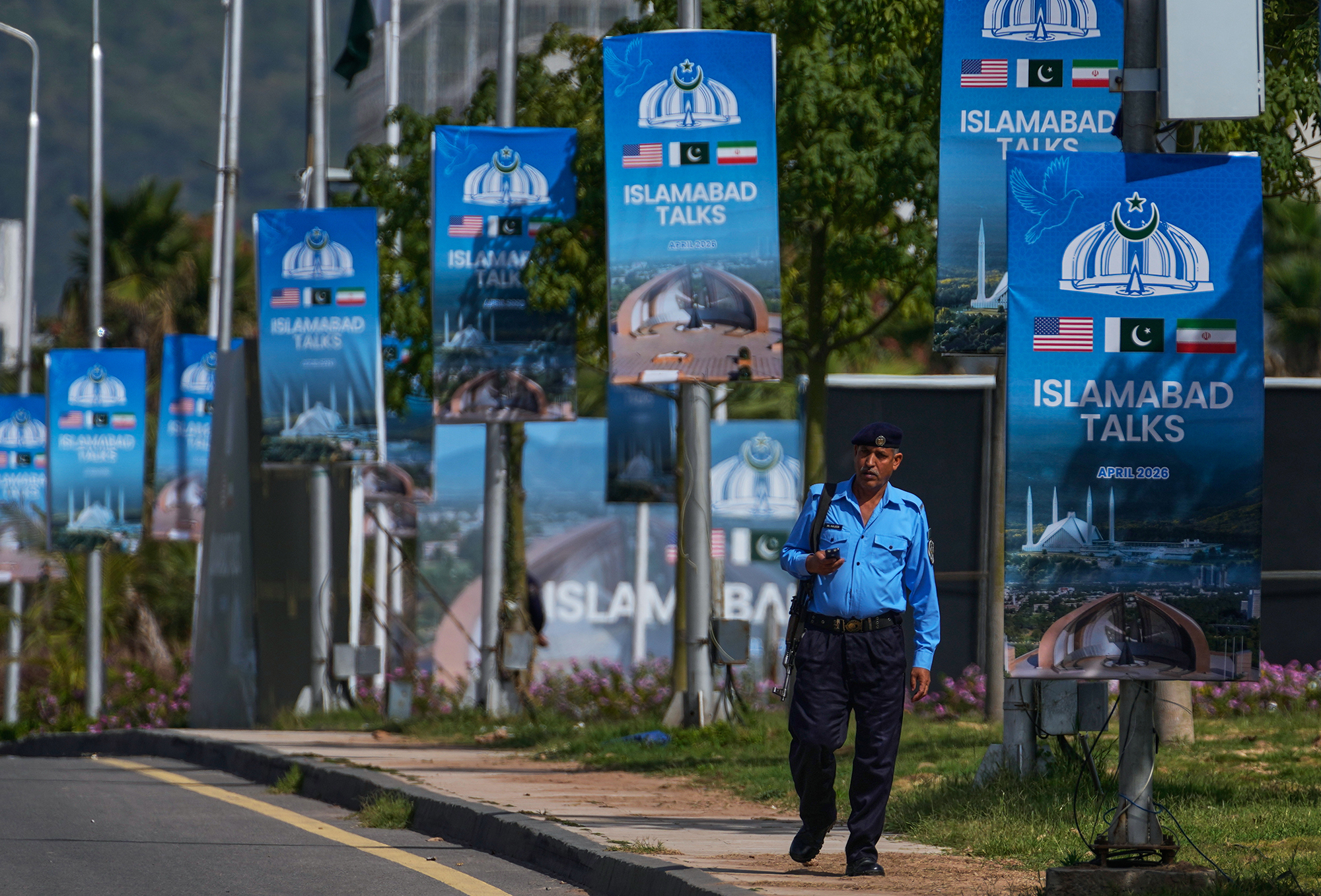 Billboards advertise what would have been the second round of negotiations between the United States and Iran in Islamabad, Pakistan, on Tuesday. (Anjum Naveed/AP)
