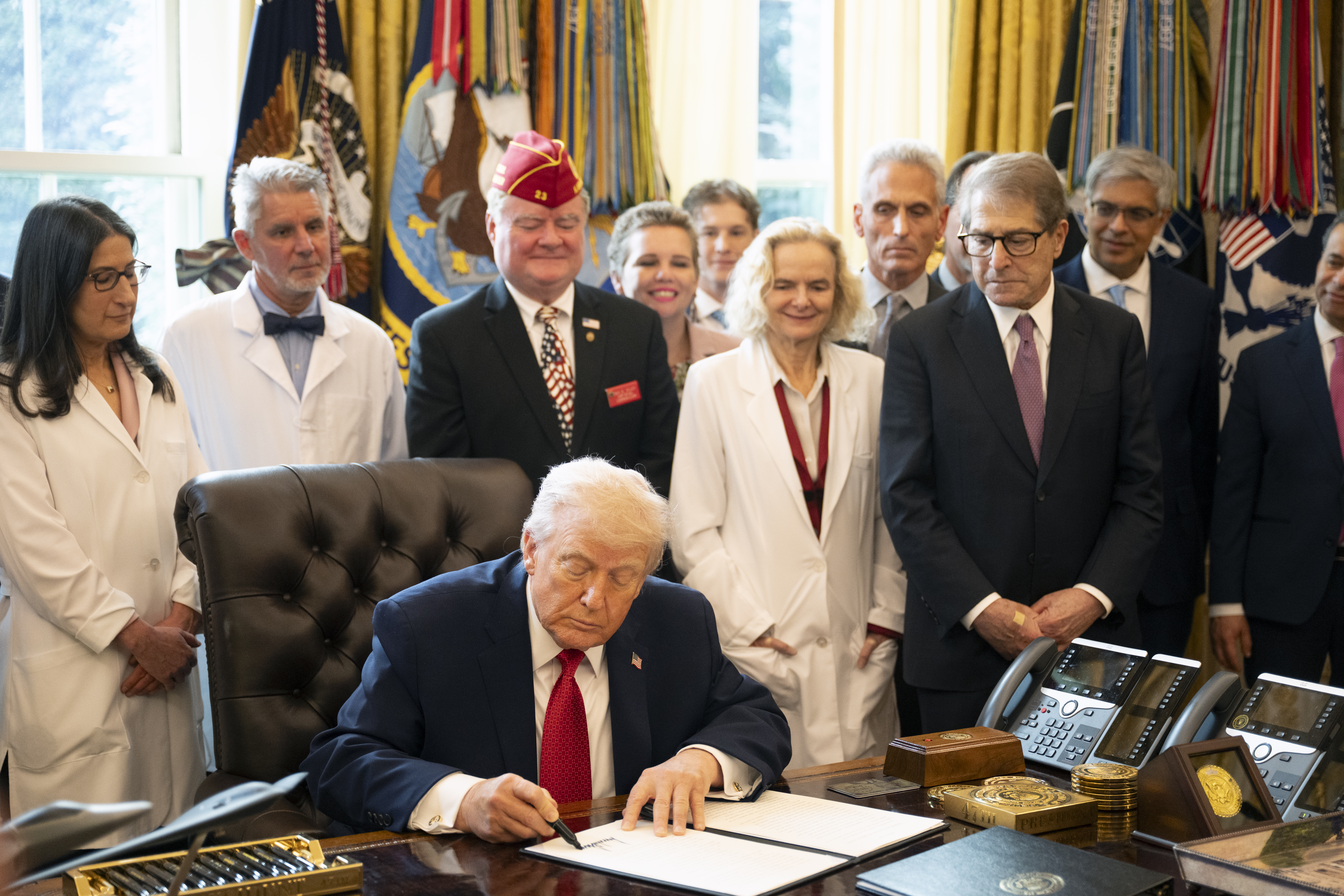 President Donald Trump on Dec. 18 signs an executive order on loosening federal regulations covering marijuana. (Marvin Joseph/The Washington Post)