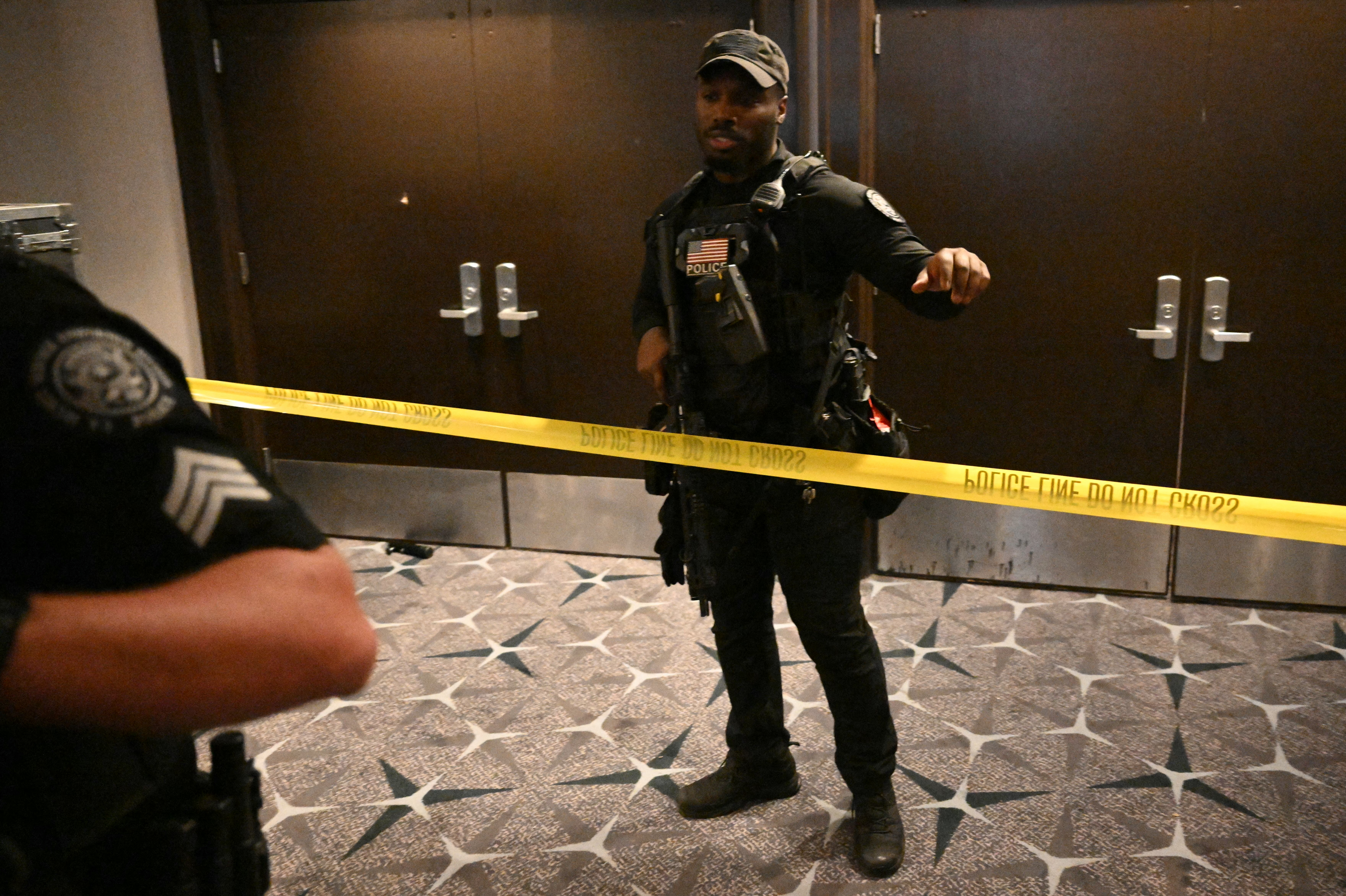 An armed police officer behind police tape during Saturday's White House correspondents' dinner at the Washington Hilton. (Mandel Ngan/AFP/Getty Images)