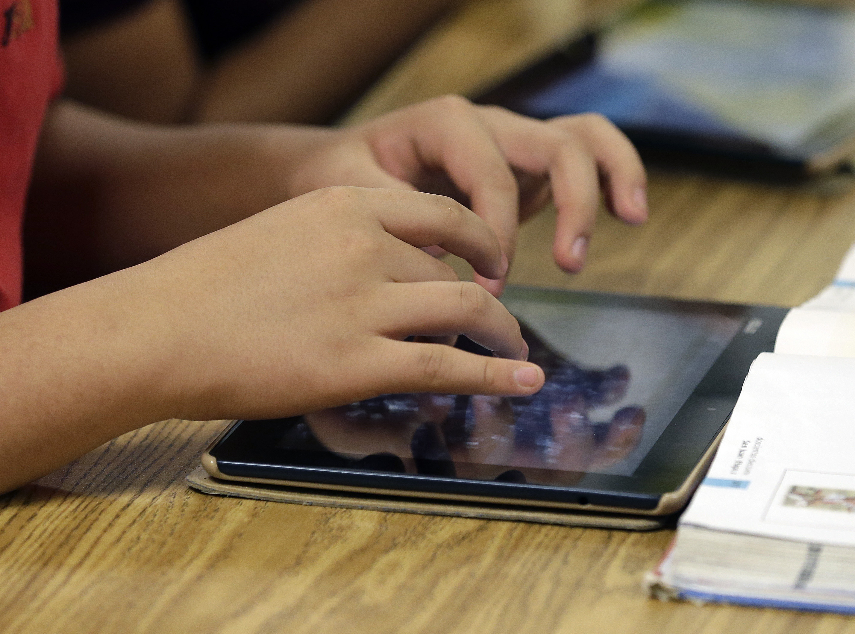 A student uses a tablet during a middle school class in Johns Creek, Georgia. (John Bazemore/AP)