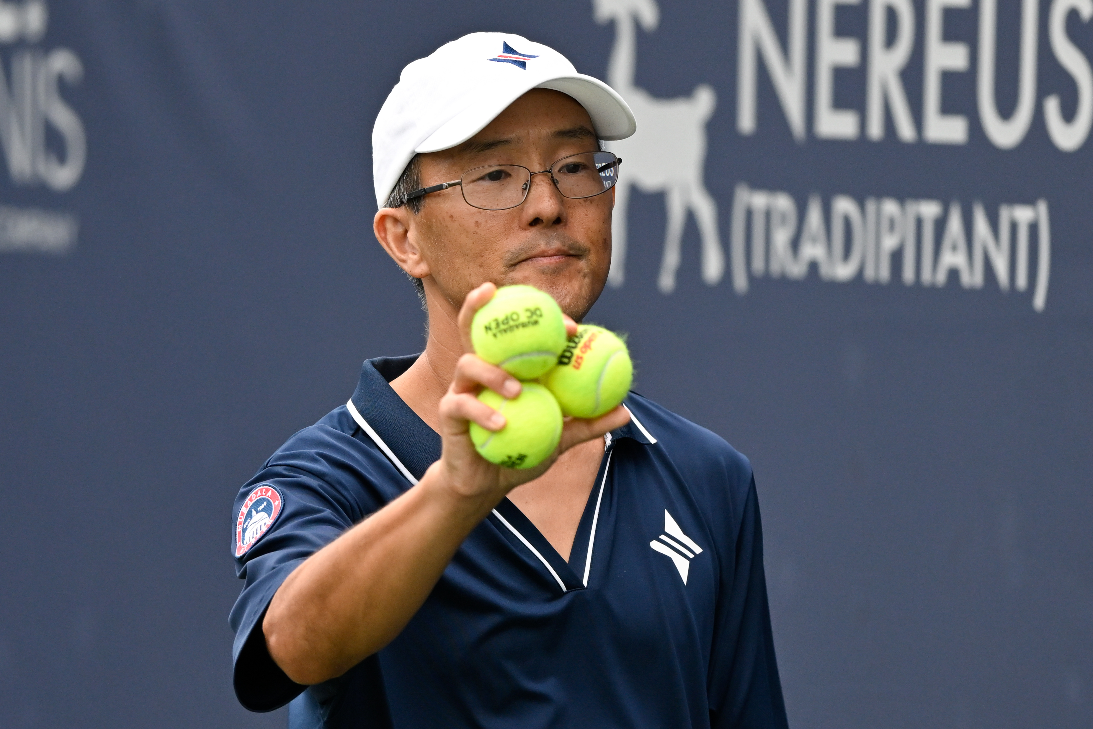 Tai, 54, has worked as a ball person in tennis tournaments since the 1980s. (Hannah Foslien/For The Washington Post)