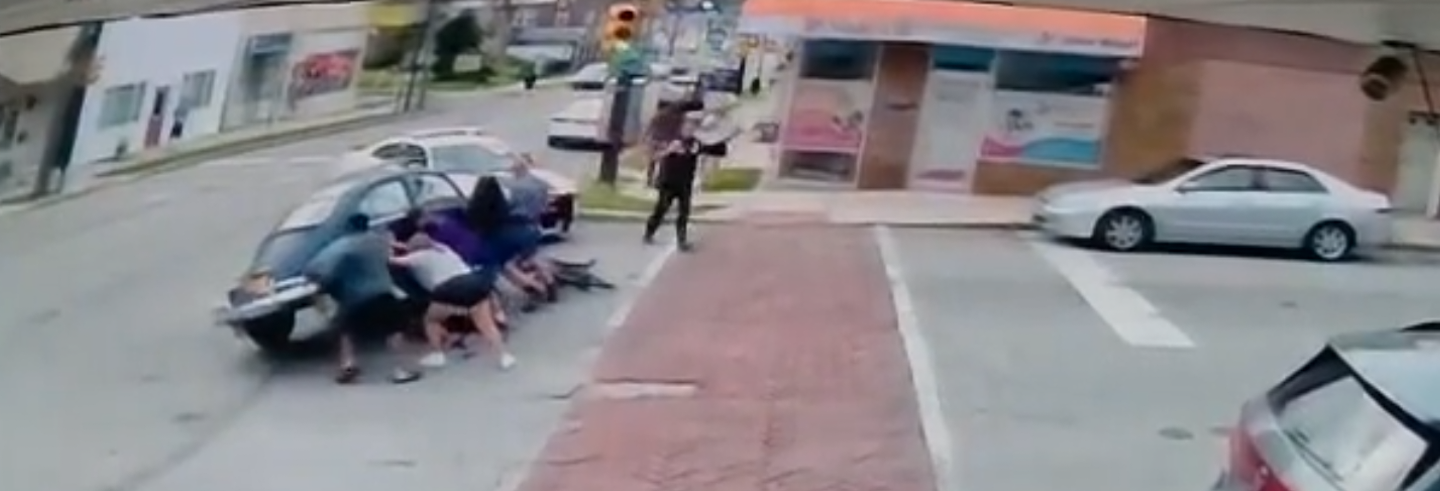 Bystanders lifted the side of the Volkswagen Beetle a few inches off the street. (Prospect Park Police Department)